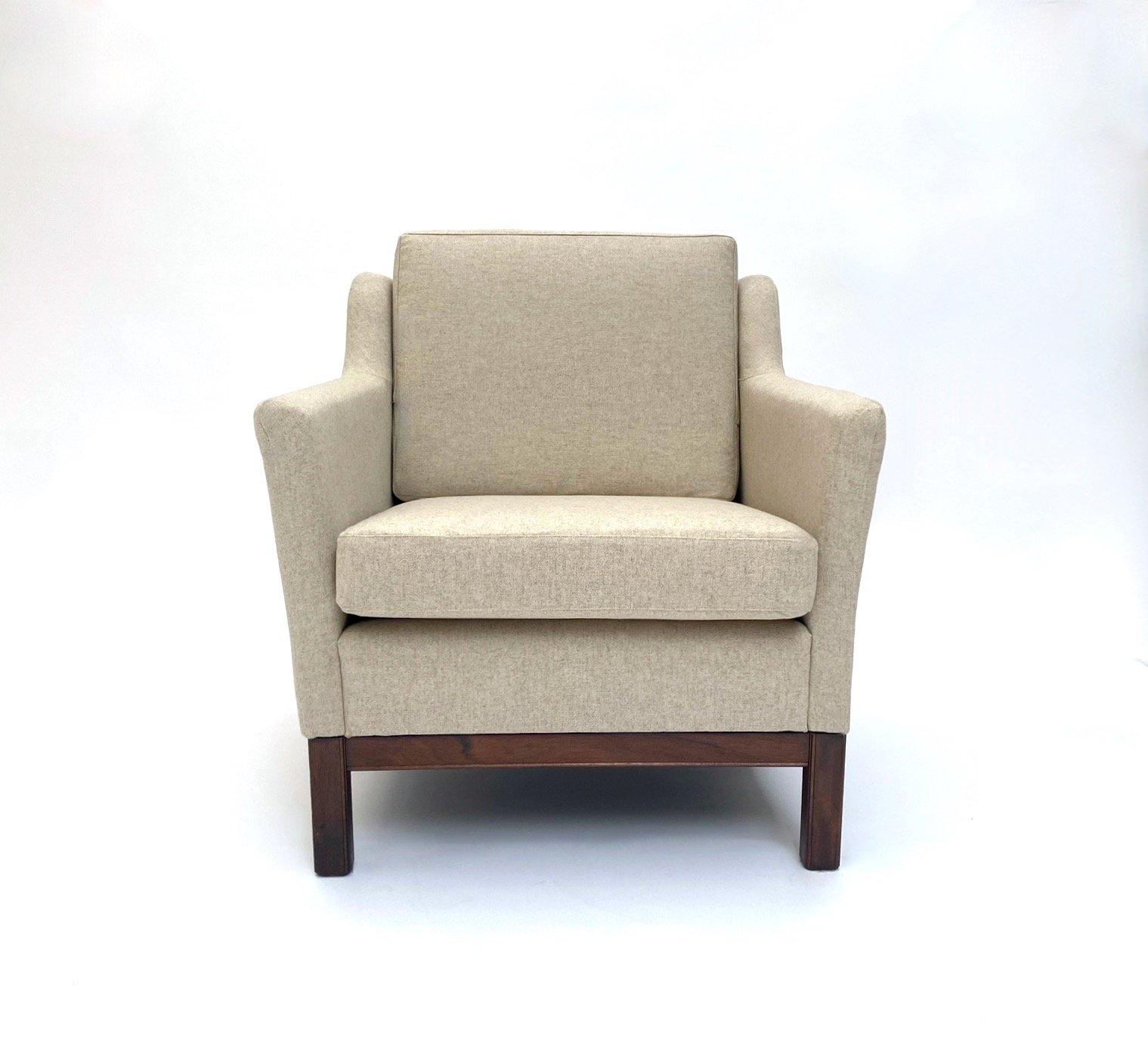 A beautiful Danish cream wool and teak armchair, this would make a stylish addition to any living or work area.

The chair has a wide seat and padded backrest for enhanced comfort. A striking piece of classic Scandinavian furniture.

The chair is in