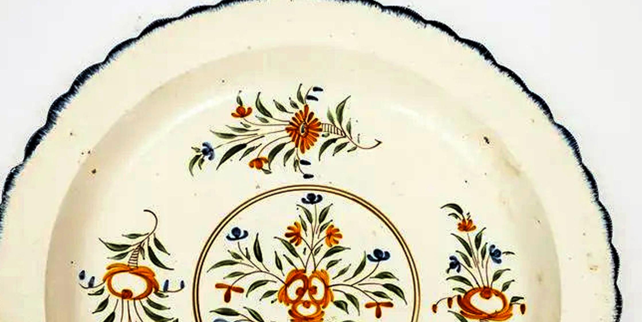 Creamware dish with polychrome botanical decoration,
Circa 1790

The large circular creamware pottery dish with a blue shell edge with painted floral sprays. 

Dimensions: 14 1/4 inch diameter x 2 inches.

Provenance: Montaine Collection, With