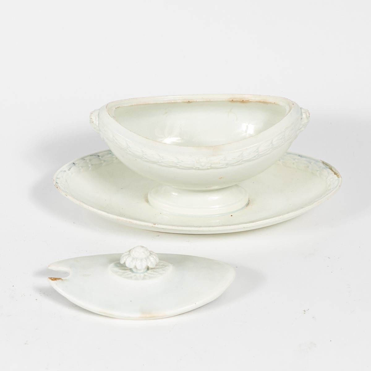 Creamware or faïence fine sauce-boat with saucer from late 19th-century France. Faïence is a type of ceramic pottery that allows for colorized decoration due to its tin glaze; faïence fine refers to what was known in England as creamware. Suitable