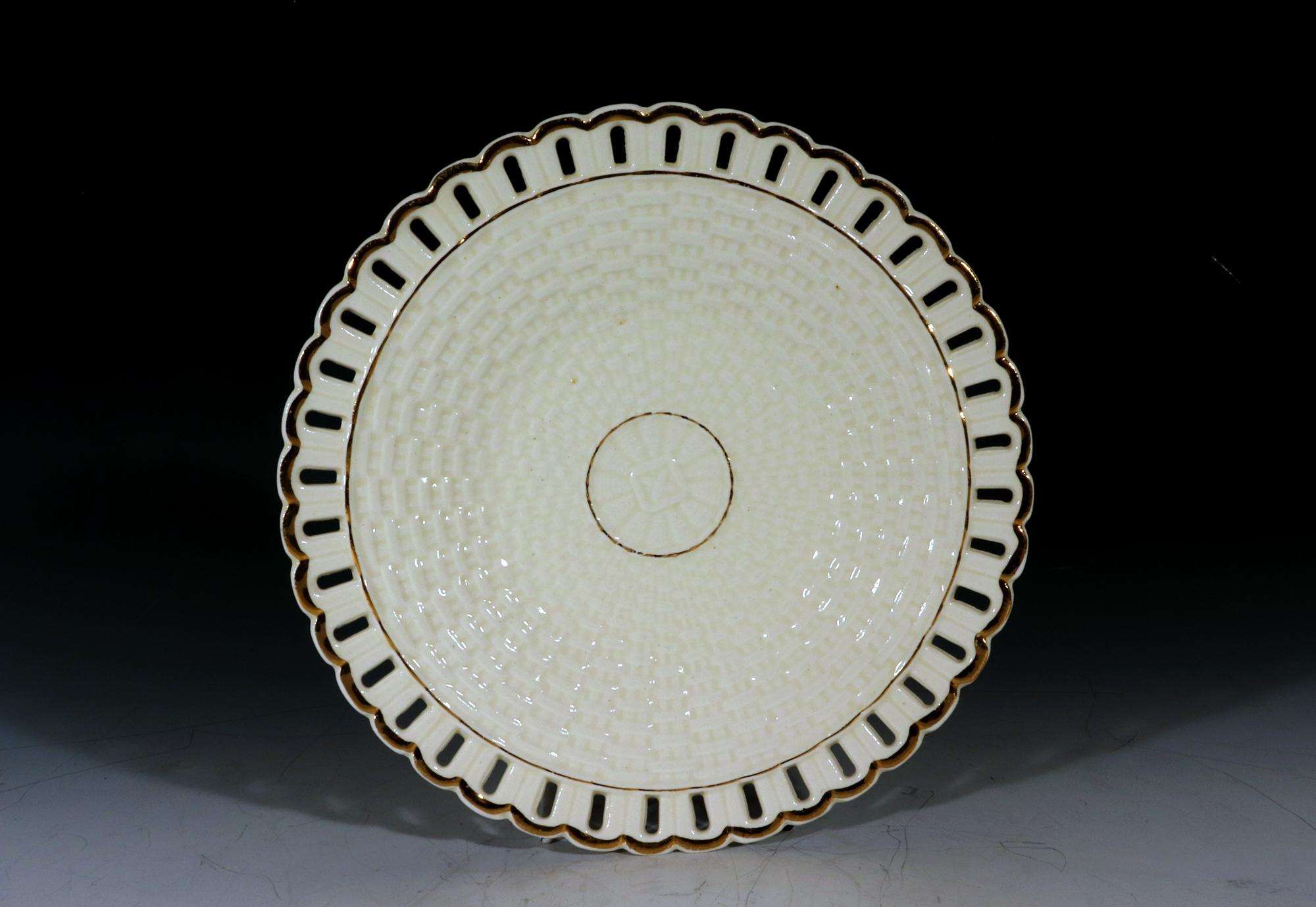 Set of Seven Continental Creamware Openwork Dessert Plates

The basketweave creamware plates have an openwork reeded border with a gilt rim. The basketweave becomes tighter as it reaches the central roundel with a different weave