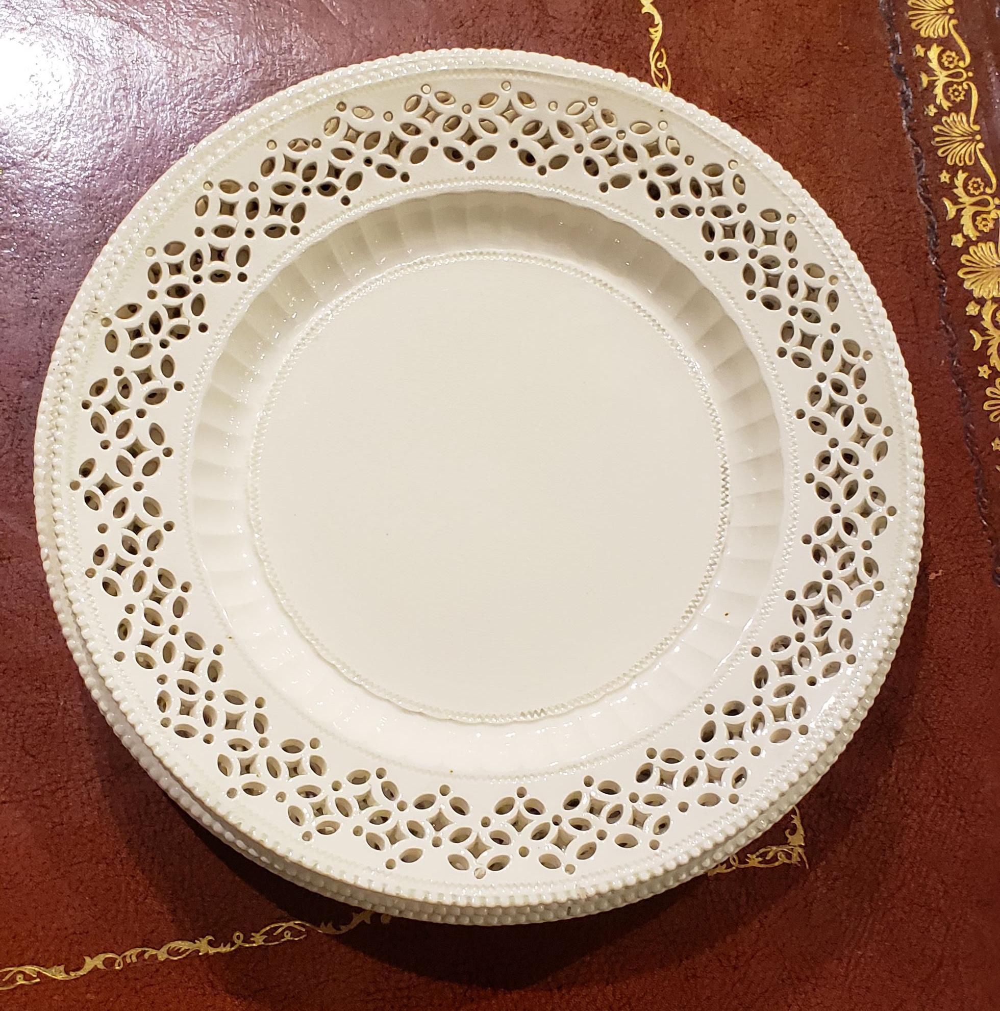 Creamware openwork dessert plates,
circa 1790.


A set of three creamware plates with pierced borders- three and one slightly smaller. Each plate with an inner border edged with concave reeded indentations and the rim pearled.

Dimensions: