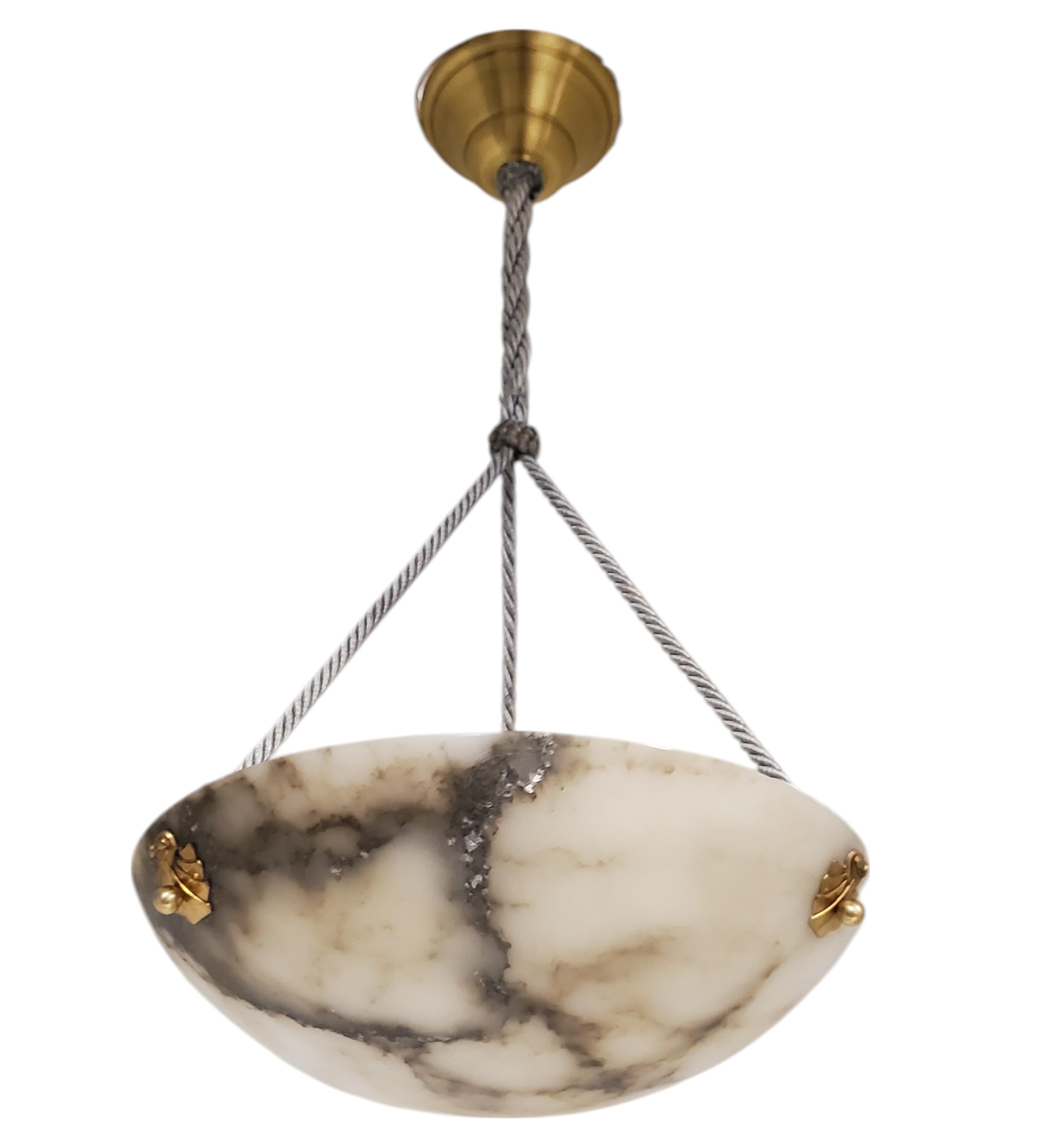 Un élégant et authentique lustre à suspension en albâtre de style Art déco français, magistralement sculpté dans une gracieuse silhouette de bol. 
La pièce présente un veinage saisissant dans des tons contrastés de gris tourterelle et de charbon de