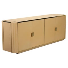 A 1970s sideboard by Alain Delon for Mario Sabot, made of cream-lacquered wood.