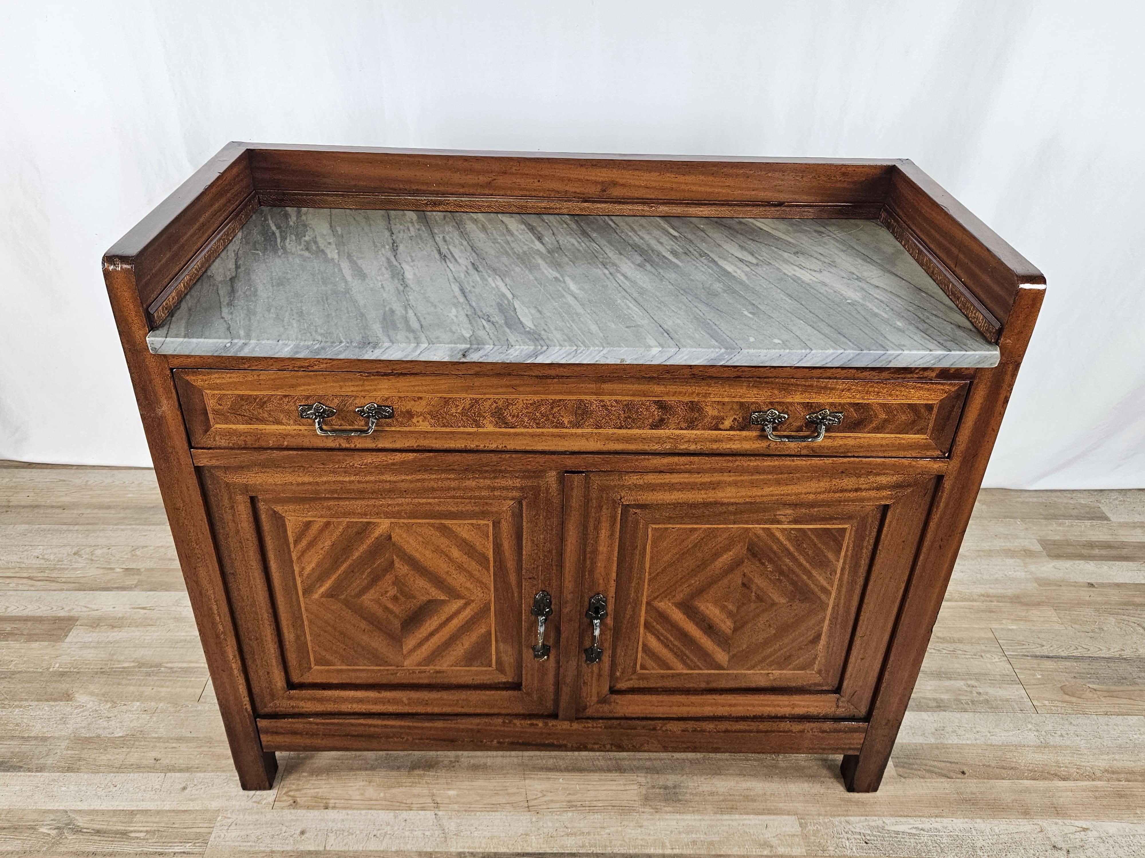 Elegant Art Nouveau-style dressing table from 1910/20, Italian made in walnut with ornate details and brass floral handles.

A multipurpose cabinet, it can be used in an entryway as an emptying cupboard or in a bedroom as a dressing table or