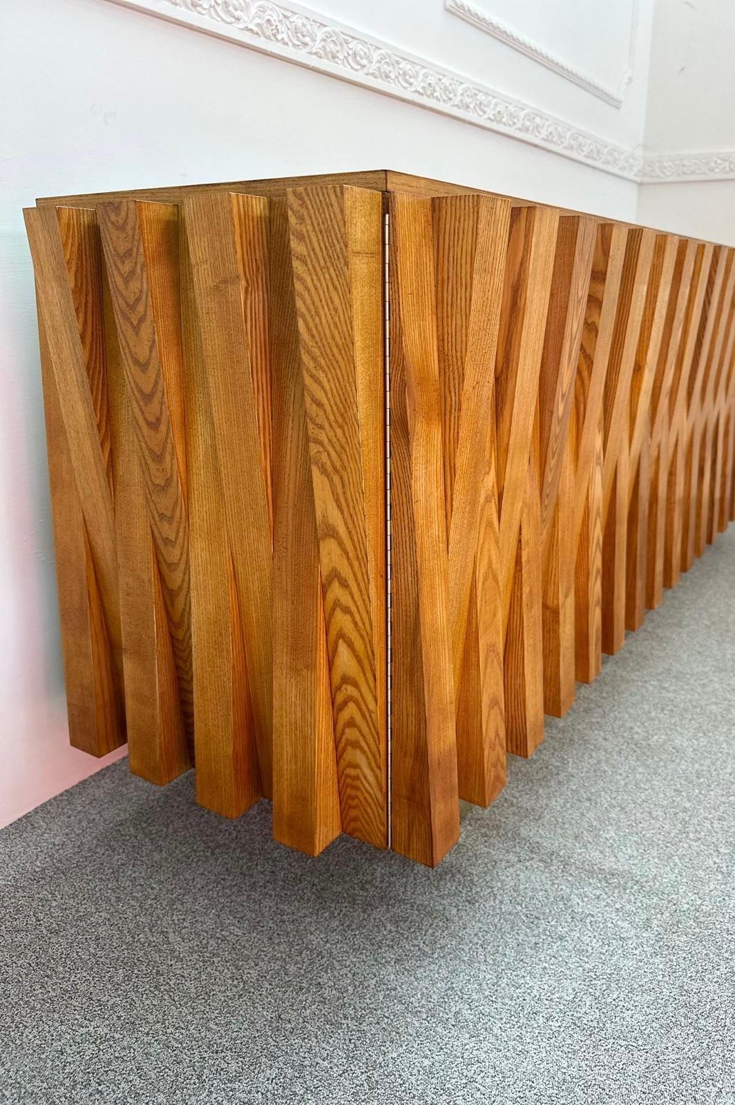 Brutalist Credenza designed by French architect Gaetan Pullanghiel. Handcrafted in solid ash wood, commissioned by the Hotel Colosseum. Rome, 1980s.

