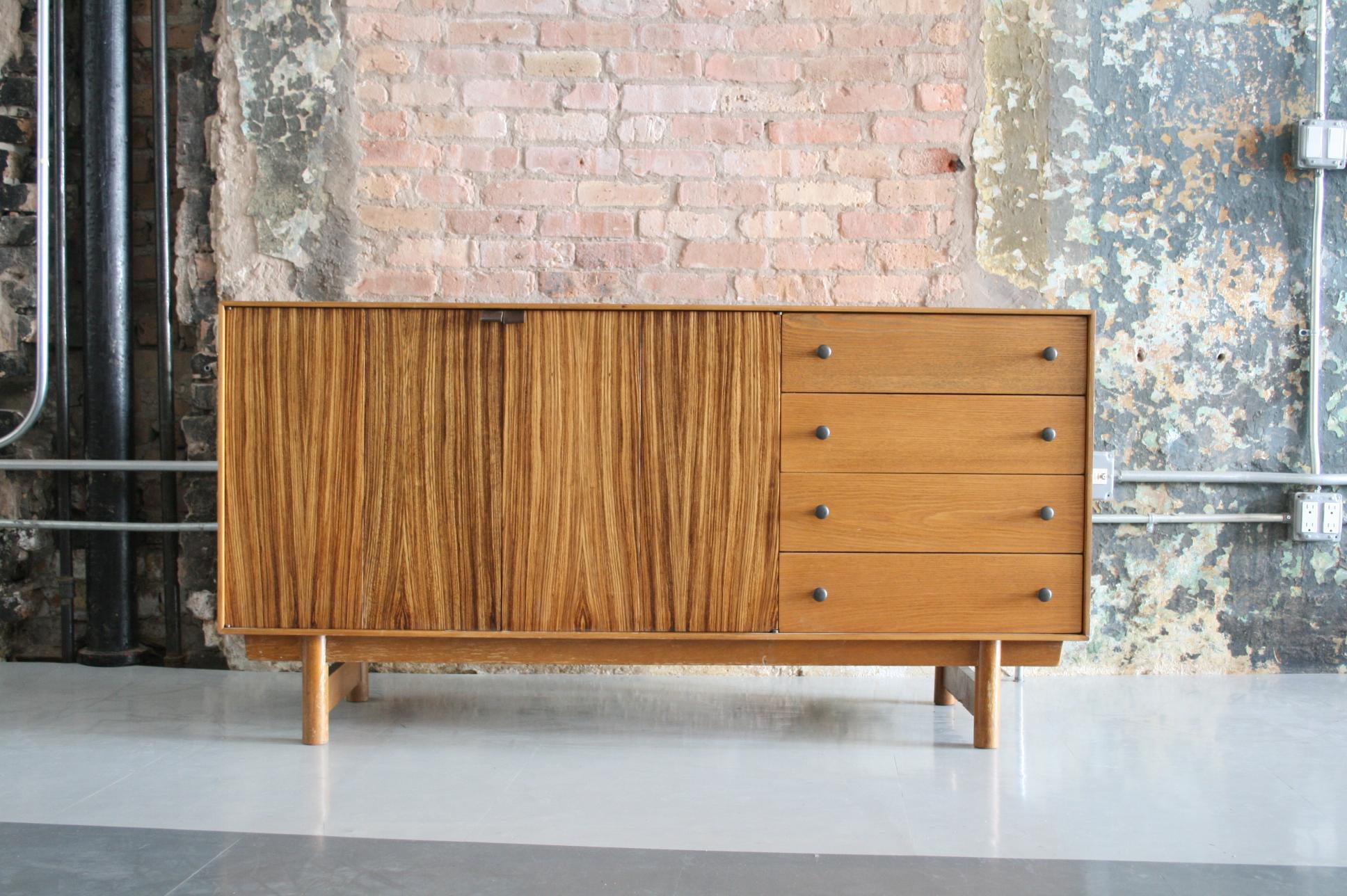 The American designer Lawrence Peabody, trained in Denmark and the Scandinavian influence, was clearly evident in this fabulous credenza. A very Wegner-esque embrace of the natural wood, quality construction, and subtle detailing are stand-out