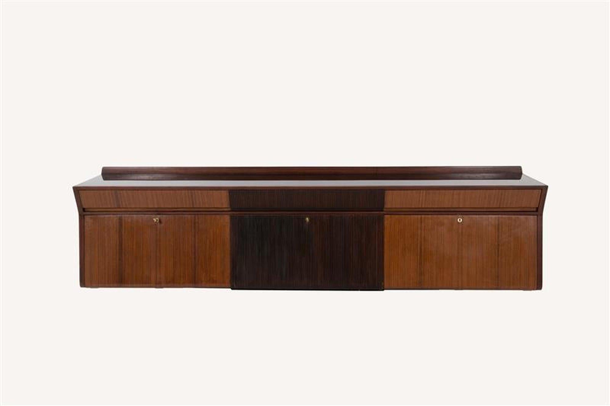 Attributed to Osvaldo Borsani (1911-1985) for Arredamenti Borsani sideboard with bar Italy, 1940s rosewood, wood, brass, black glass, mirrored glass unmarked

Cabinet features three upper drawers and three drop-down doors concealing open shelving
