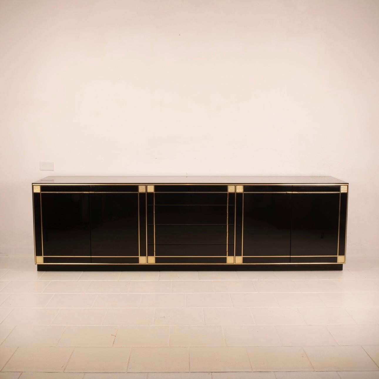 Extraordinary vintage Pierre Cardin sideboard, an authentic work of design art, produced by Roche Bobois in black lacquered wood, mother-of-pearl and brass. With its bold brass lines and glossy black lacquer, this sideboard embodies the elegance and