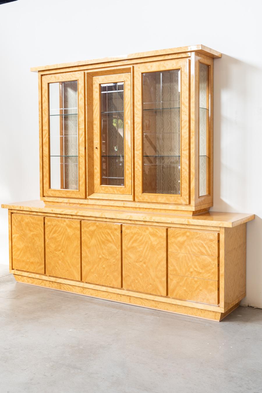 Sideboard with display case, 1980/1990
Sideboard cabinet, with crystal display case, made of birch briar, with 	glass shelves, gold painted iron handles, beveled glass. The 	interior window covering [ in drawn velvet. 1980/1990
	Measurements Glass