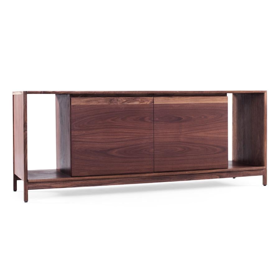 A simple but robust cabinet. Its open and closed compartments give us a wide variety of storage possibilities. The different height options make the interior shelves versatile. Produced in three different types of wood: tzalam, walnut and oak. Every