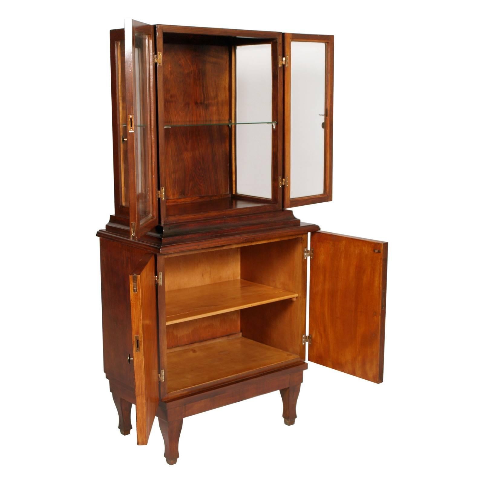 Italy Art Deco elegant and charming credenza display cabinet  by Cantù in walnut and walnut veneer,  Paolo Buffa attributed. Beveled crystals and brass accessories
Measures cm: H 93 add 83 W 85 D 50/40 
Internal shelves display H 35cm
Internal