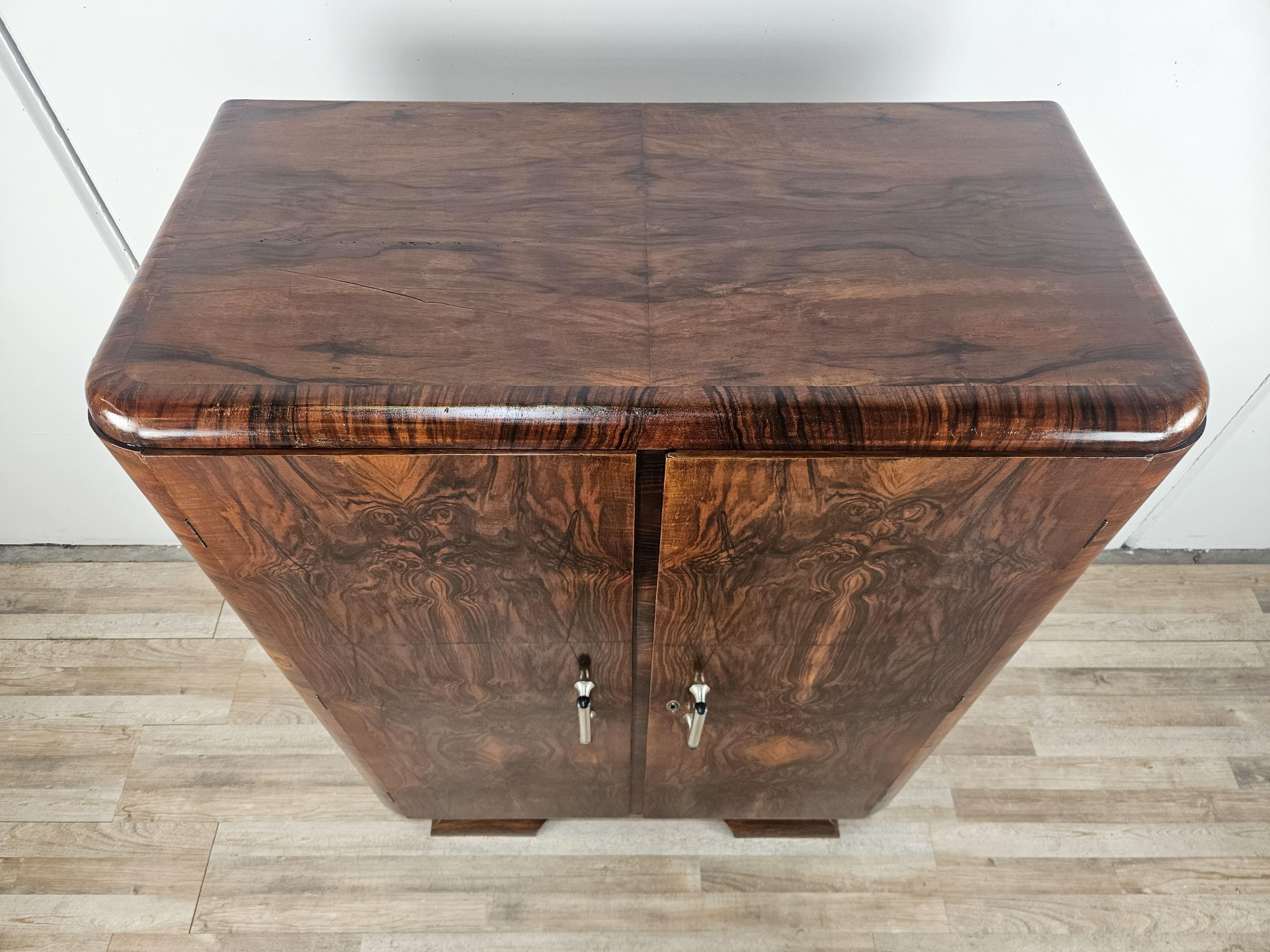 Fine French mahogany burlwood sideboard from the early 1930s Art Deco period with metal handles.

The cabinet can be used as a sideboard or as a chest of drawers given the internal shelves and drawers, and is adaptable to any context and decor