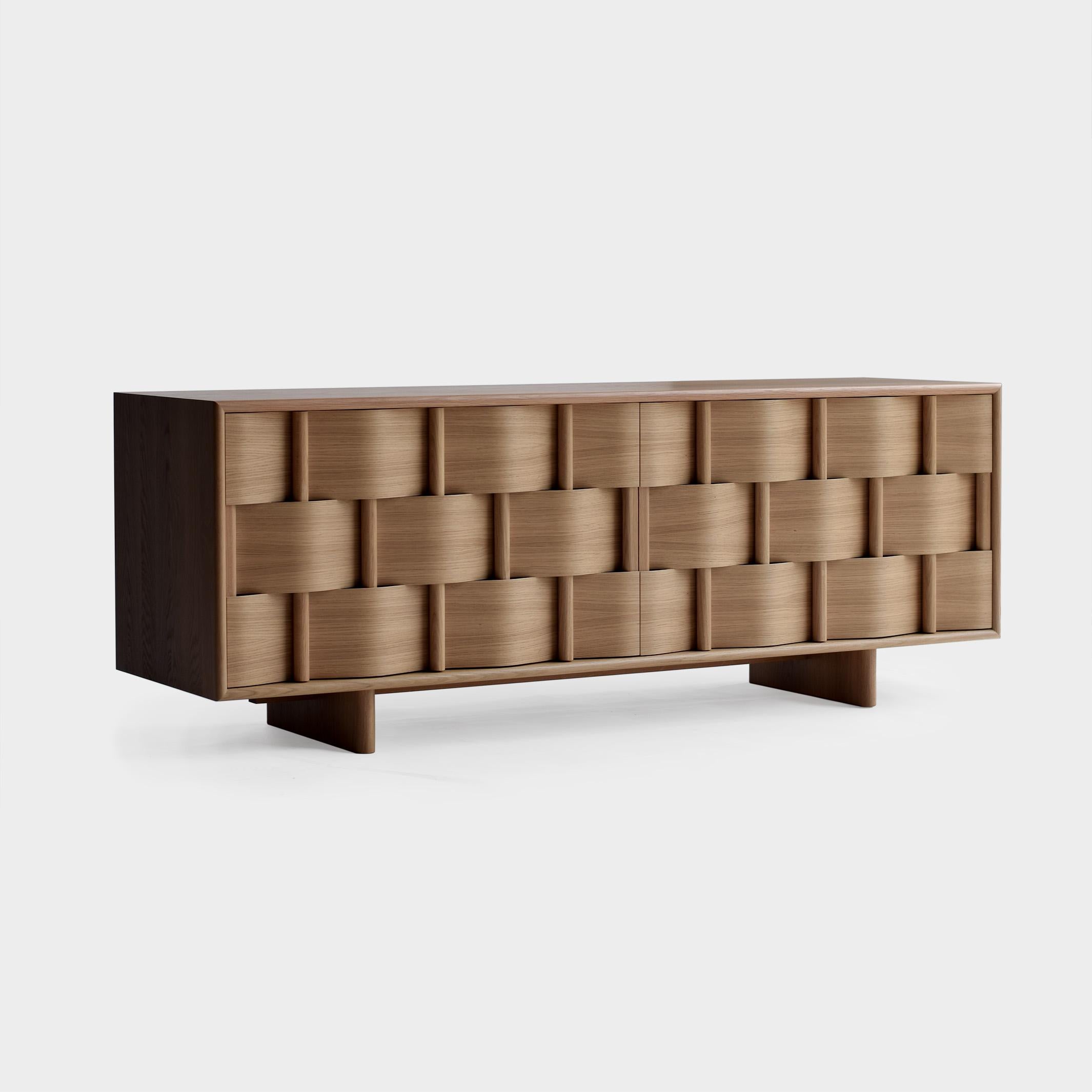 Weave frame 
Sideboard, made of solid wood and laminated veneér. Modern yet classic, bold yet modest the cabinet serves as a great example of scandinavian contemporary design. Designed by Lukas Dahlén.

The minimal yet expressive sideboard weave is