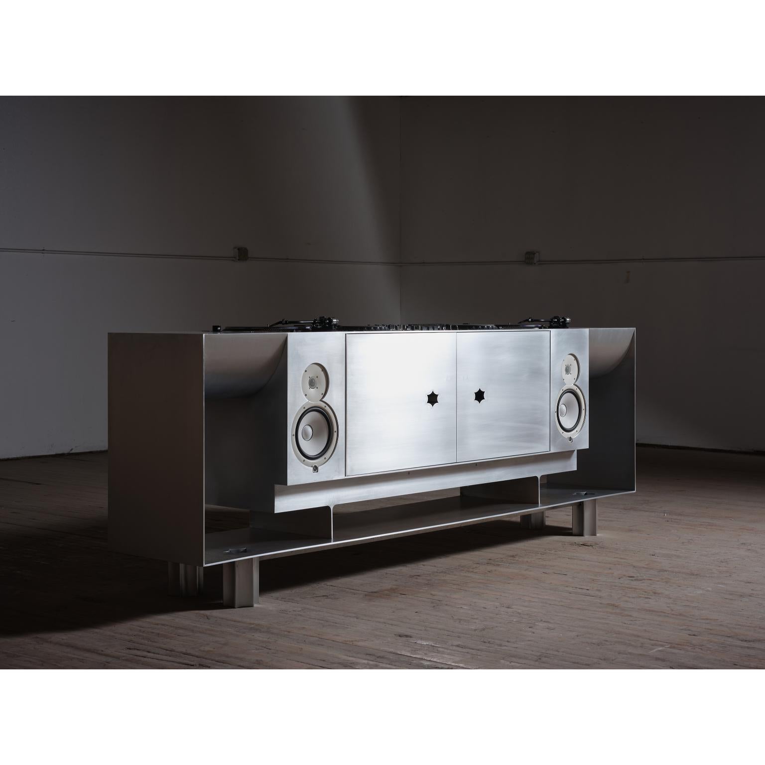 Credenza in Aluminum by Asher Gillman
Dimensions: D 50,8 x W 279,4 x H 81,3 cm. 
Materials: Aluminum.
Based in, produced, and shipped from the US.

This Aluminum series combines the visual language of industrial processes with historic icons and