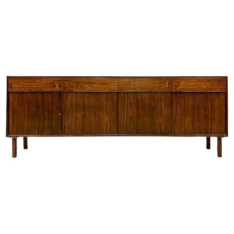 Available today, this credenza designed by Geraldo de Barros for Unilabor is nothing less than spectacular!

This credenza is made entirely of Brazilian Rosewood, also known as Jacaranda. It features three large drawers and two sets of doors, each