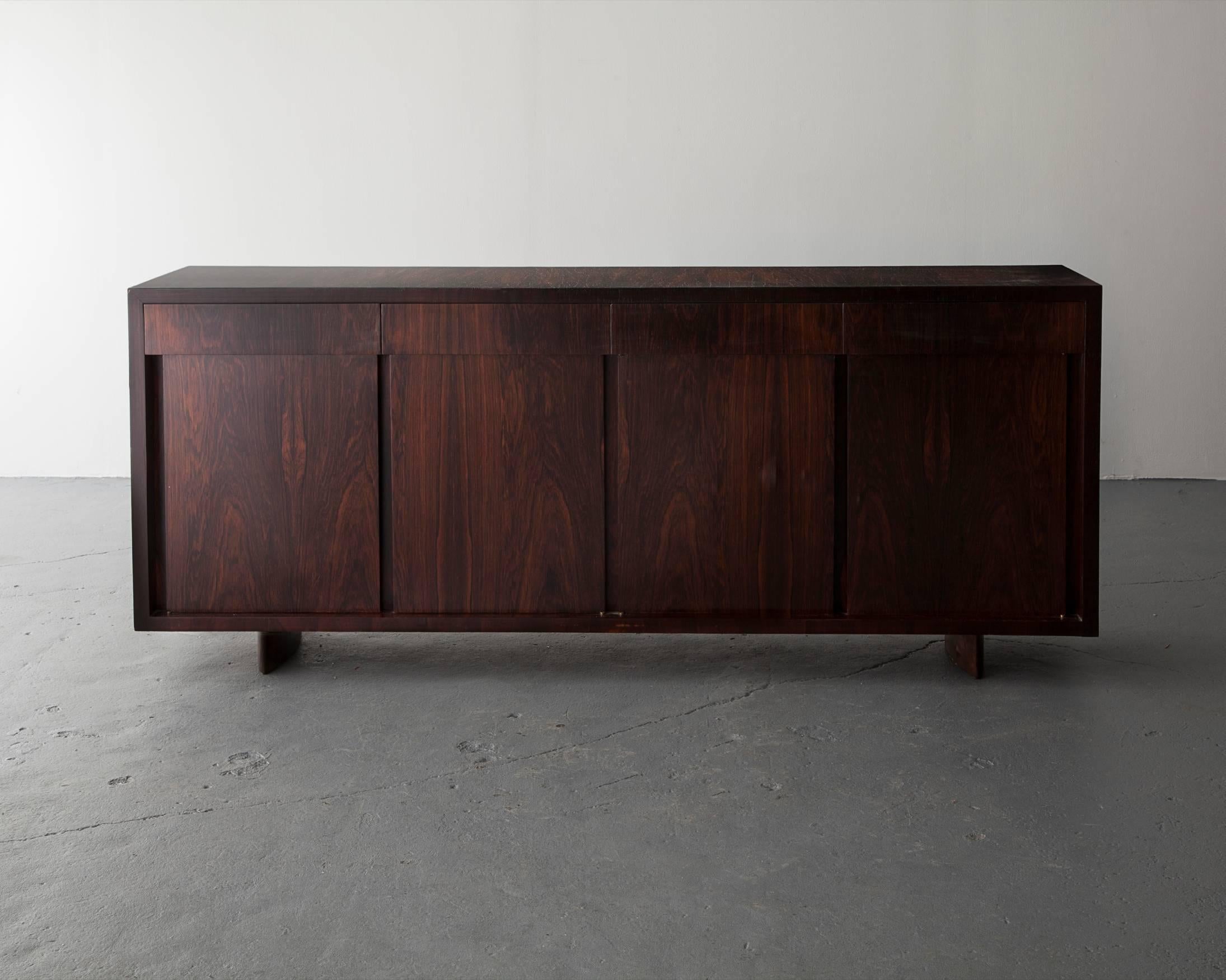 Credenza in jacaranda with four doors and four drawers. Designed by Joaquim Tenreiro, Brazil, 1950s.