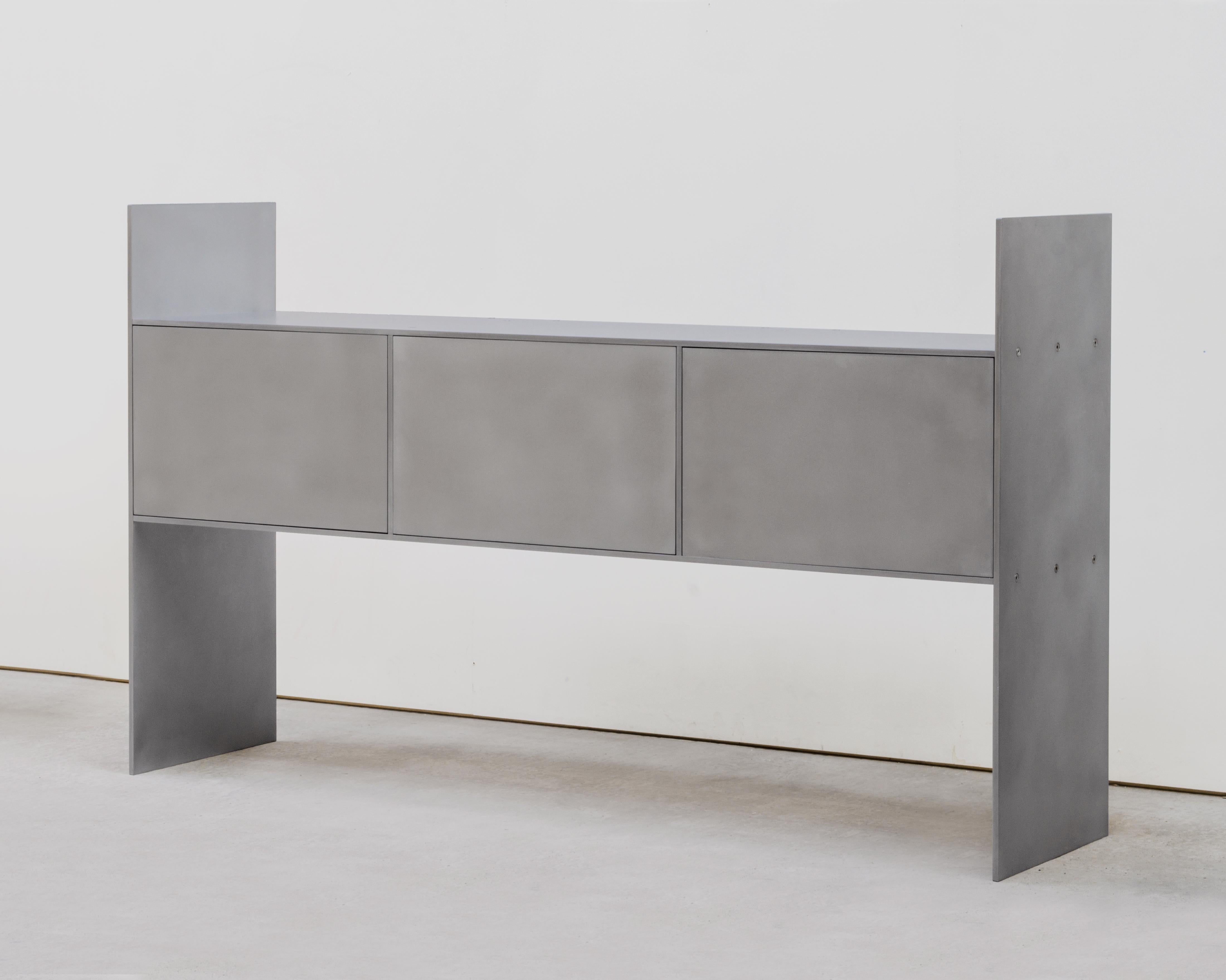 Credenza is an aluminium cabinet, designed and produced by Johan Viladrich in his atelier in the South of France. Functional and sculptural, its form is minimal yet monumental. Each part is connected to the other with stainless steel bolts so that