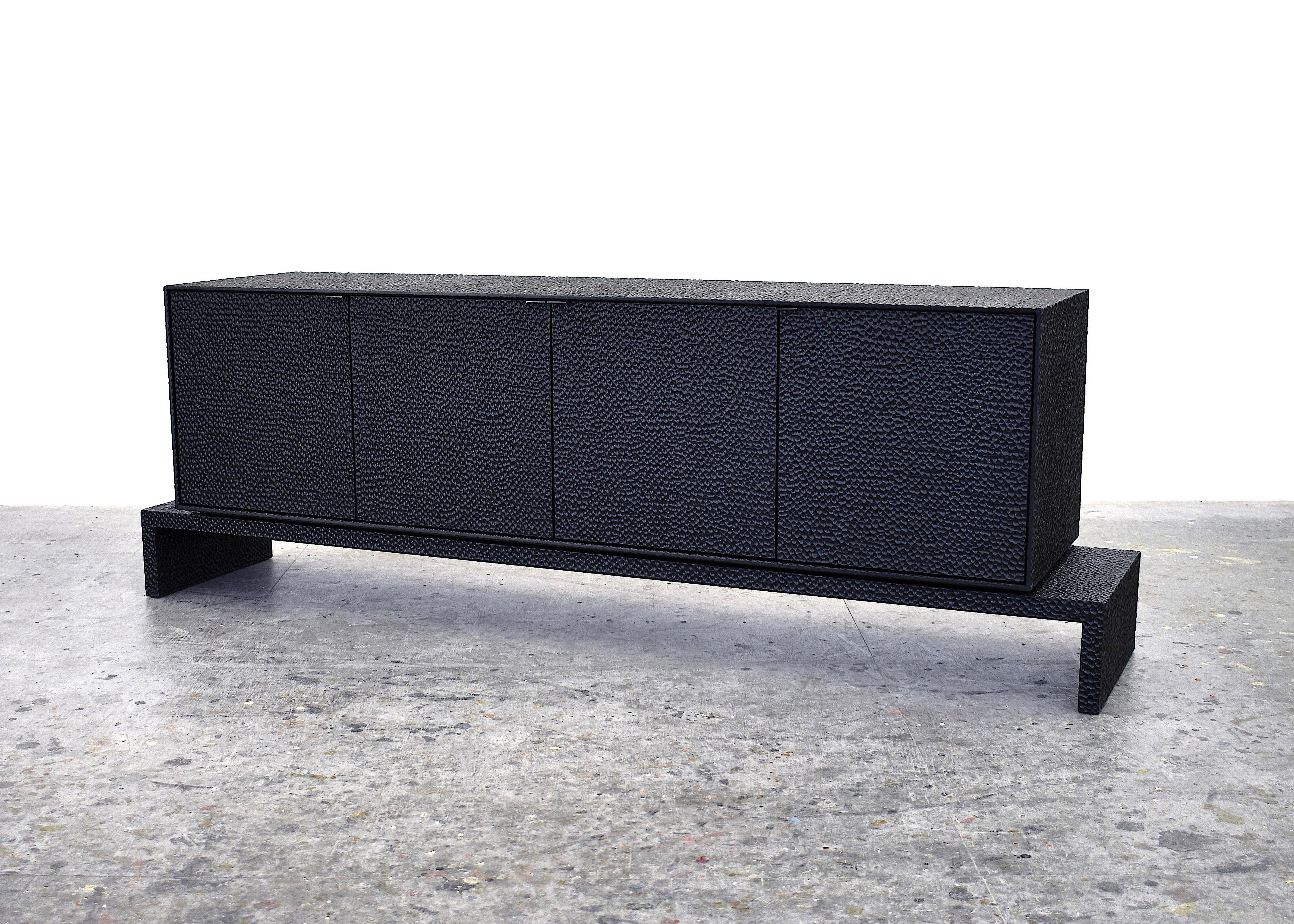 Credenza sculpted by John Eric Byers
Dimensions: 66 x 195.6 x 45.7 cm
Materials: Carved blackened maple, brass

All works are individually handmade to order.

John Eric Byers creates geometrically inspired pieces that are minimal, emotional,