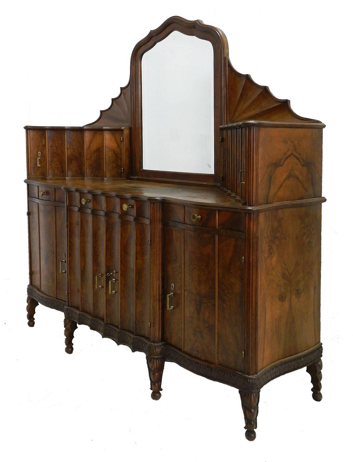 Credenza sideboard, circa 1910 Art Nouveau Art Deco one-of-a-kind Buffet
Original bevelled mirror
Figured burr walnut
Scalloped edges
Carved dark walnut
With key
Italian inspiration from antique grotto shell furniture and reminiscent of early 20th