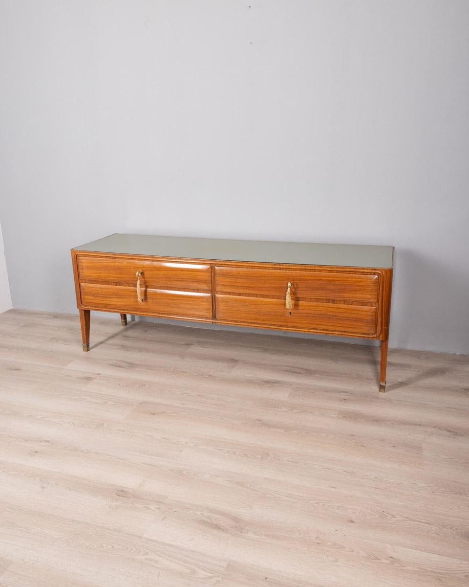 Credenza with wooden frame with gilt brass inserts and glass top, four drawers with two original keys, Italian design, 1950s.

CONDITION:
In good condition, may show signs of wear and tear given by time

SIZING: 
Height 65 cm; width 176 cm;  Length