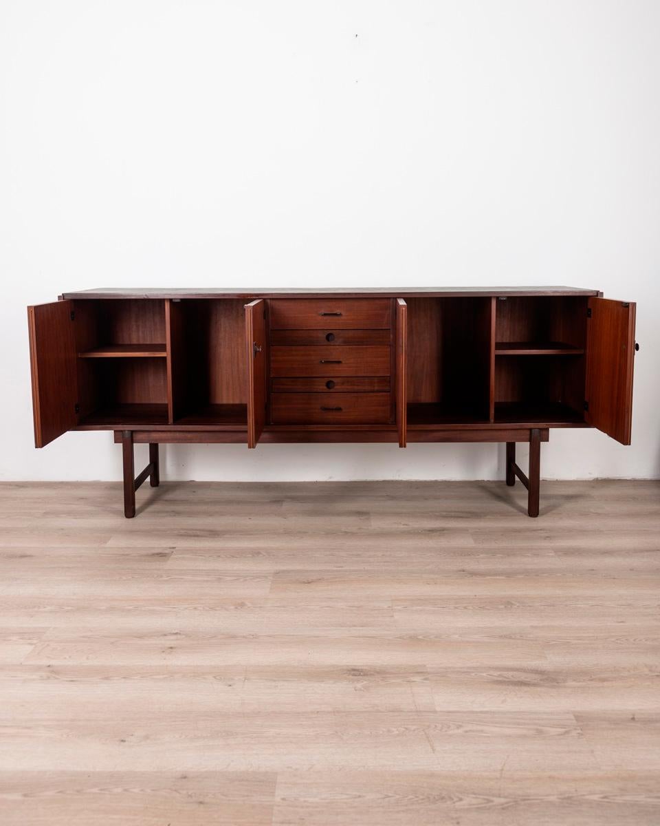 Teak wood sideboard with black top, with double side doors and central drawers, Barovero design, 1960s.

CONDITION: In good condition, may show signs of wear given by time.

DIMENSIONS: Height 87 cm; Width 202 cm; Length 45 cm

MATERIAL: Wood

YEAR