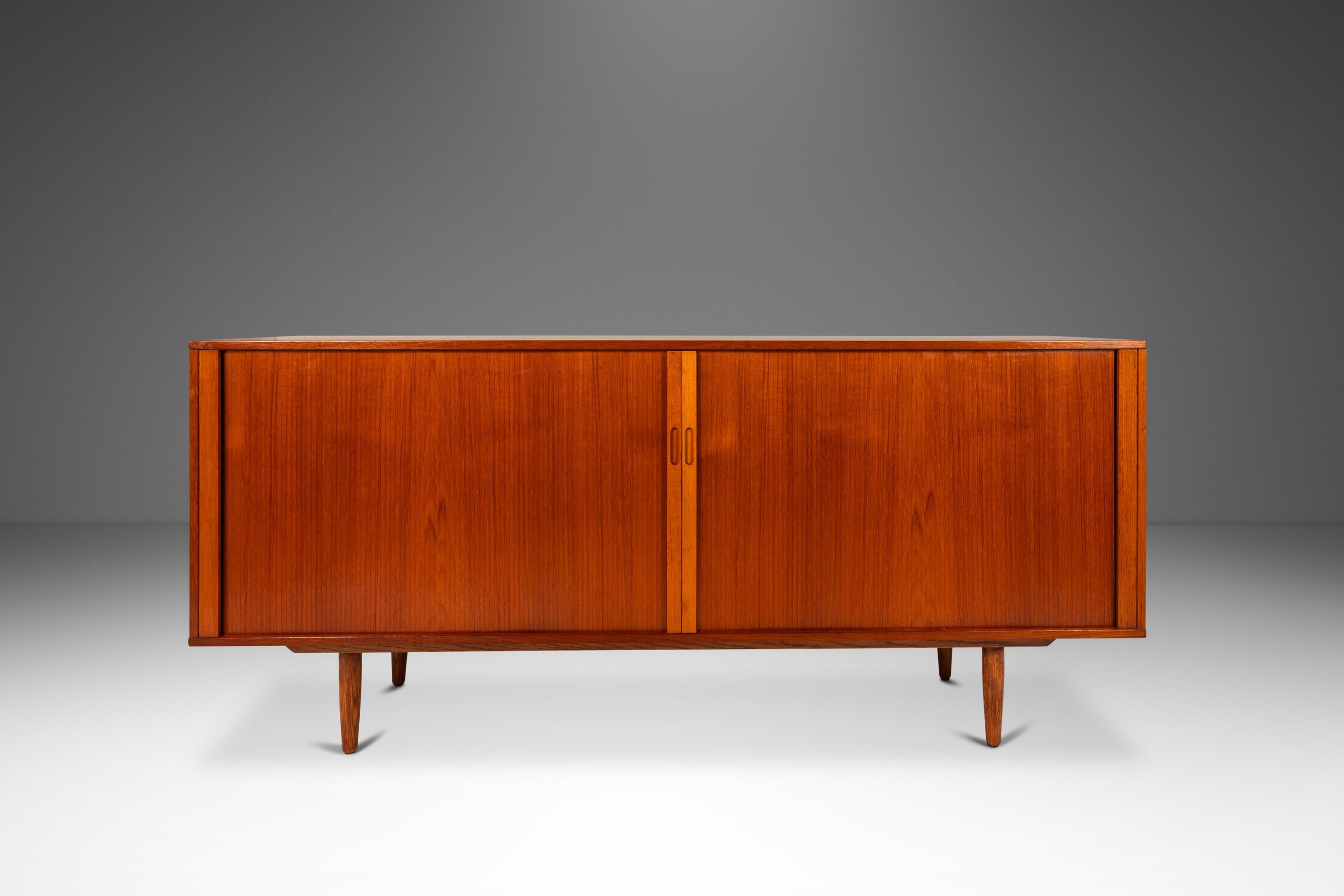 Introducing an expansive Danish-made credenza that is audacious in scope, design and materials used this extraordinary Danish-made credenza is as functional as it is visually arresting. Constructed from a mix of solid and matchbook-veneered Burmese