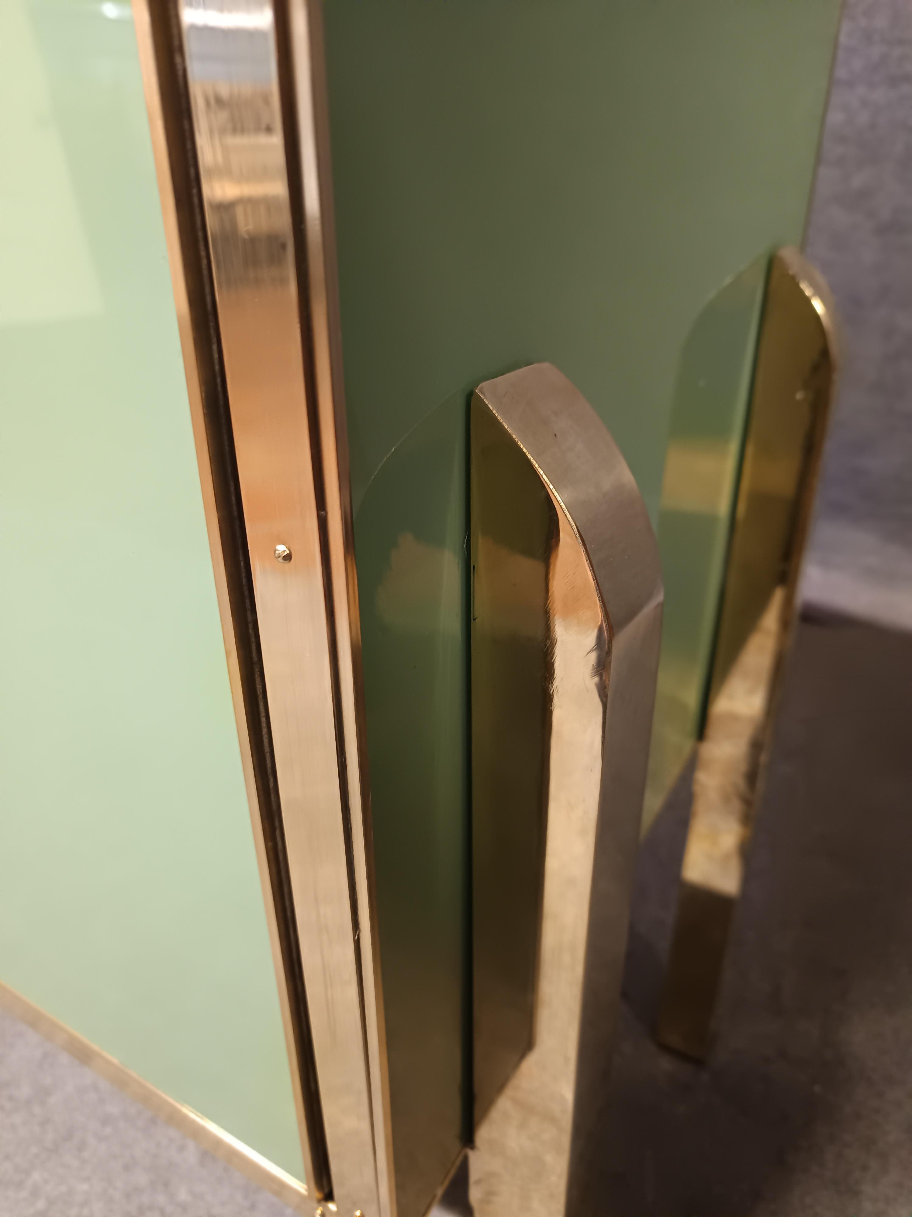 Aparador de cuatro puertas de cristal de Murano verde con herrajes y tiradores de latón 

Este exquisito aparador representa la cumbre de la artesanía italiana, gracias a su mezcla de madera de abedul, herrajes de latón y hermoso cristal de Murano