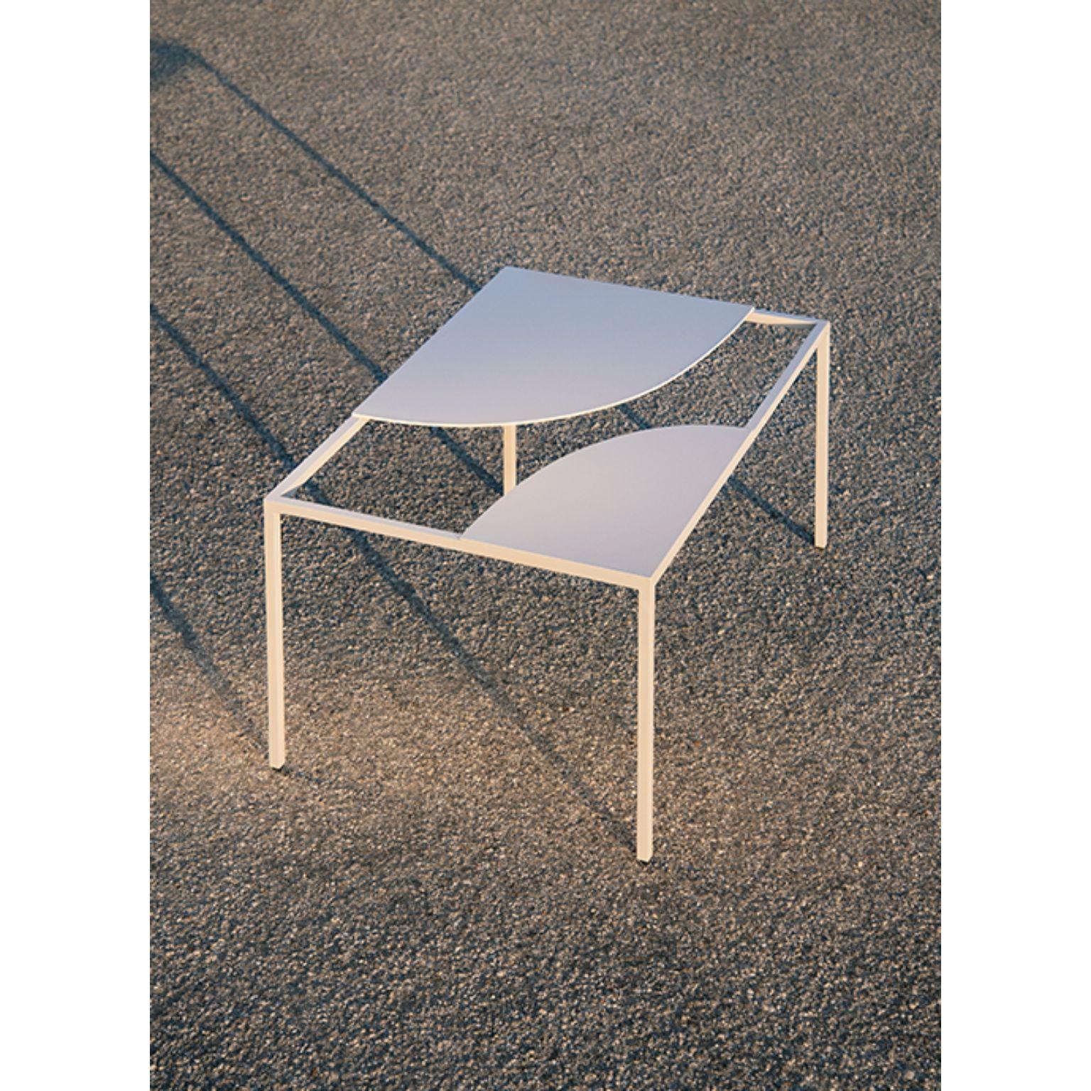 Creek coffee table by Nendo
Materials: Top: Powder coated metal
 Structure: Chrome metal
Dimensions: W90 x D60 x H31.7 cm

Creek is a table that suggests a stream of water flowing freely across its surface and around islands,
circling around