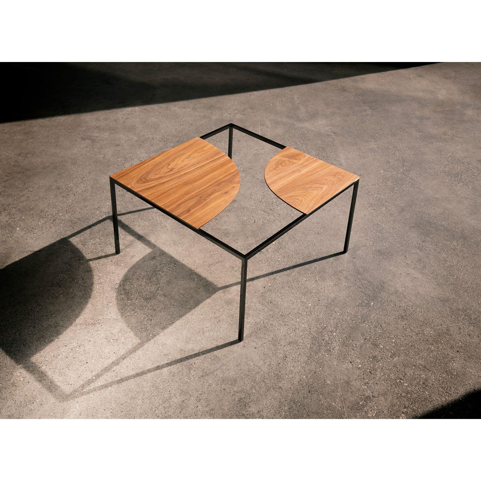 Creek coffee table by Nendo
Materials: Top: solid wood 
 Structure: Black chrome metal
Dimensions: W60 x D60 x H31.7 cm

Creek is a table that suggests a stream of water flowing freely across its surface and around islands,
circling around the