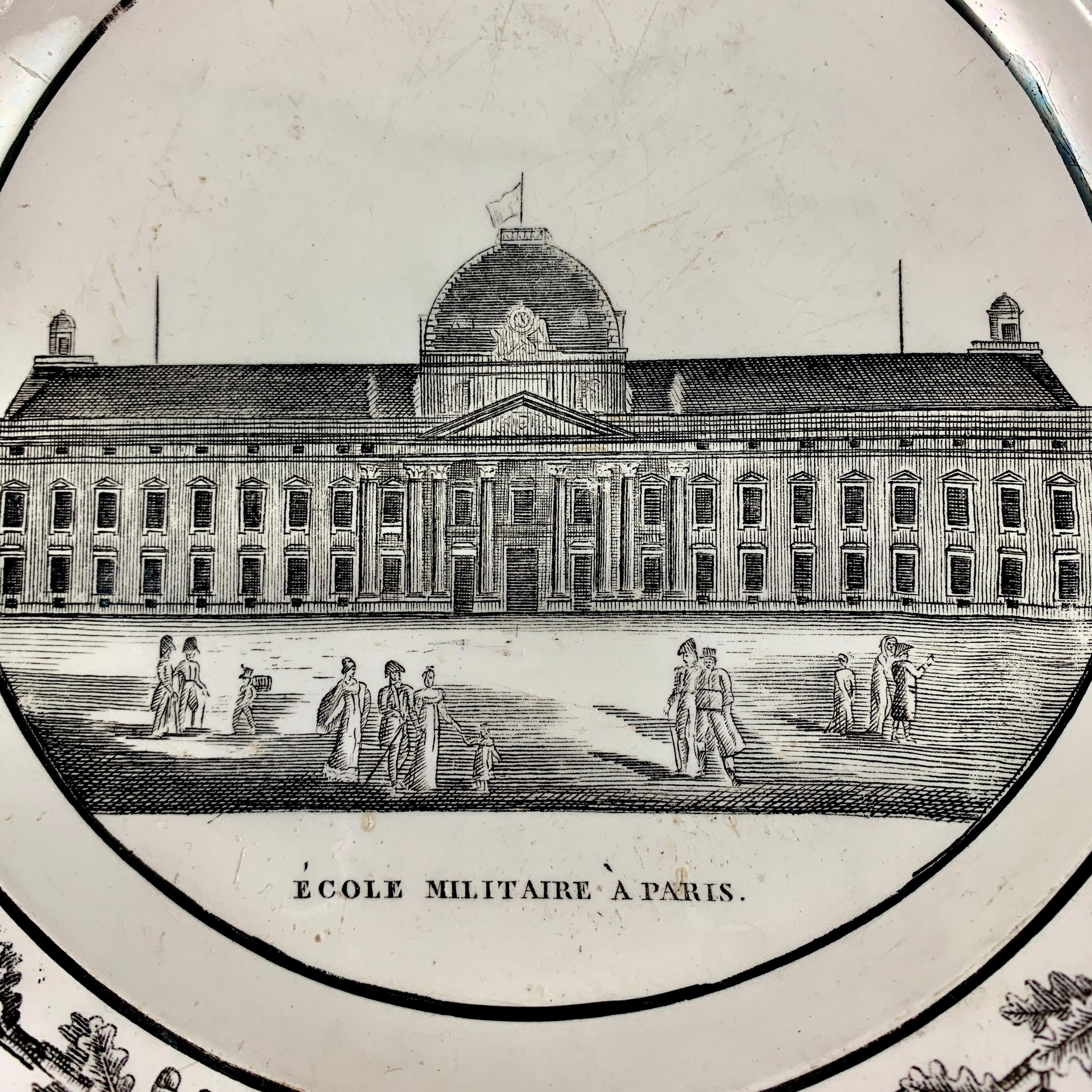 A French faïence neoclassical transfer printed plate from Creil ét Montereau, circa 1820-1830.

A black transfer of an architectural image on a creamware body, depicting the École Militaire à Paris. The domed building is prominent, with figures in