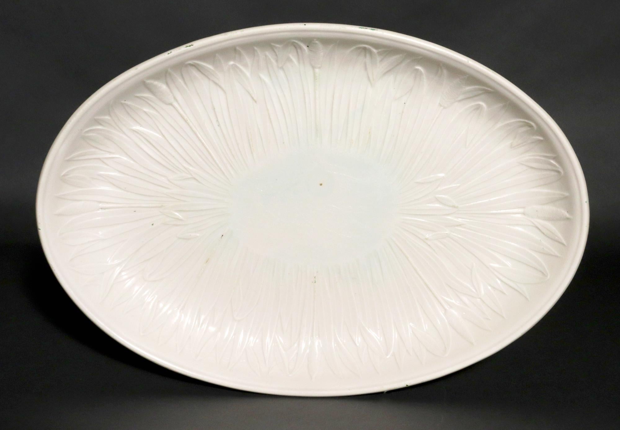 Creil Faience Fine Creamware Dish,
Circa 1800-20

This charming French creamware dish is decorated with a molded design of bullrushes encircling the dish. The crisp design displays beautifully against the creamy background of the dish. The dish