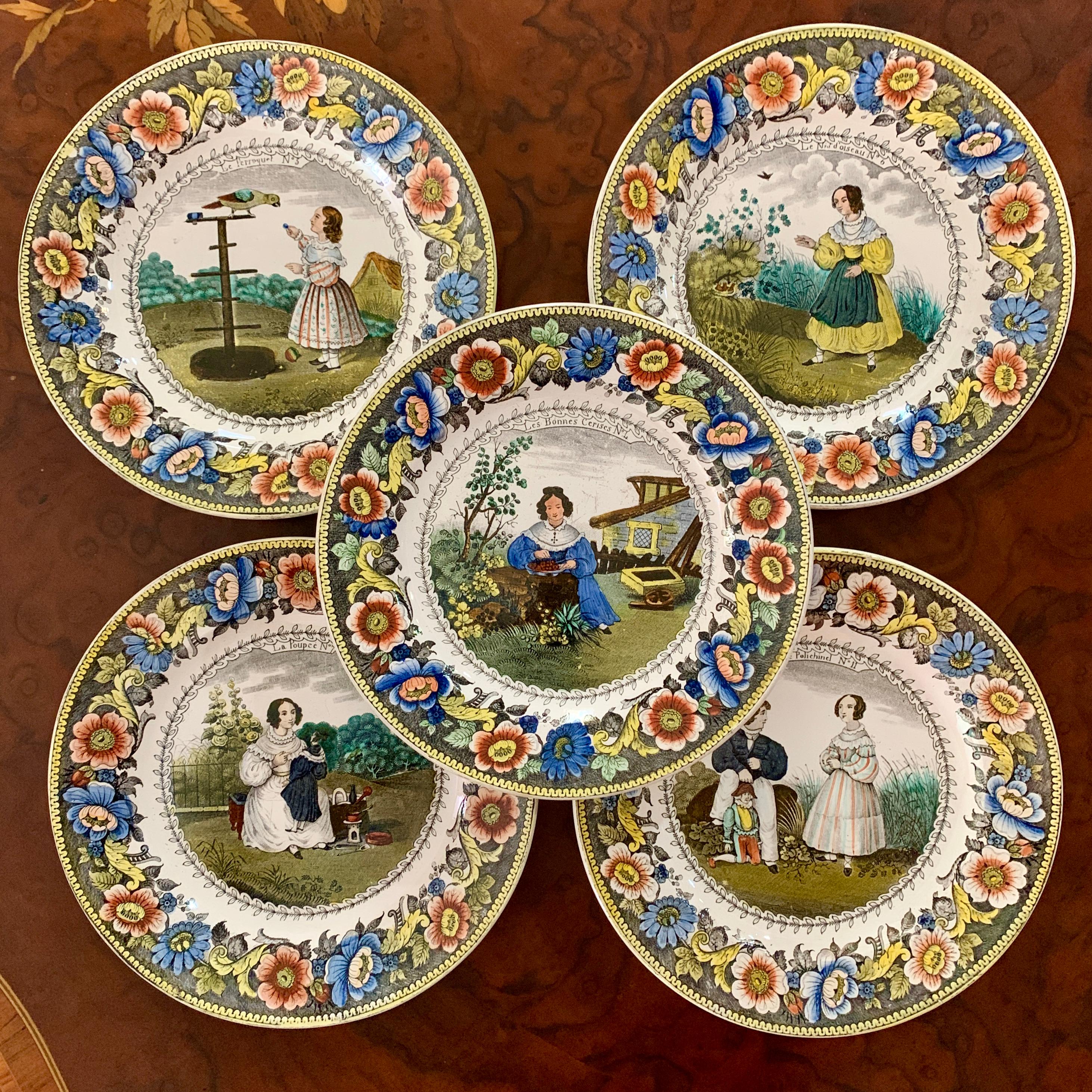 From the Creil region of Northern France, a transfer printed polychrome plate, titled – La Poupeé (the doll) Circa 1830.

The image shows No. 7 from a series of twelve. A young lady in a white period dress, takes a moment from her gardening chores