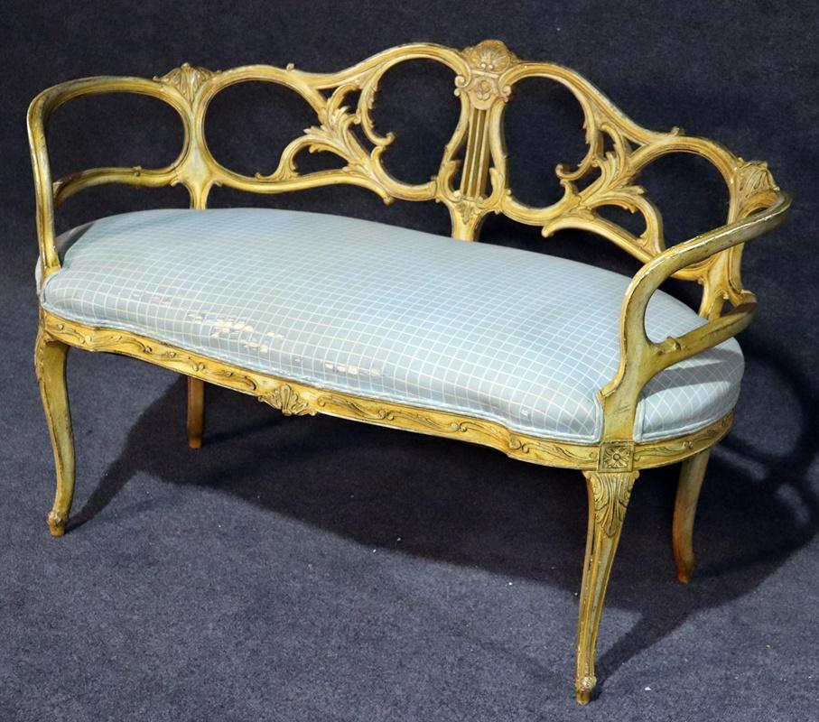 This is a superb and very unique French Louis XV style settee or window bench. This gorgeous bench would look wonderful in front of your bed or against a wall. The frame is beautifully carved and finished in an antique painted finish with a subtle