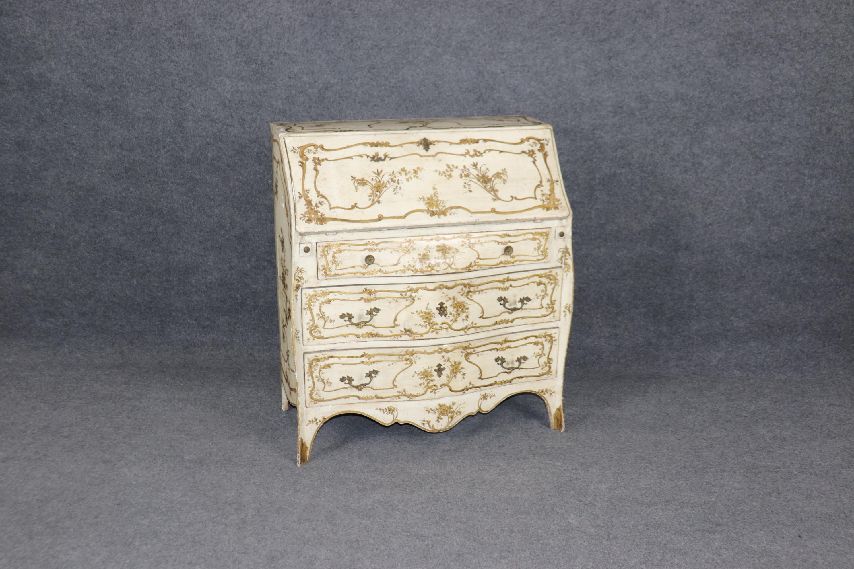 This is a superbly painted and aged Italian Rococo style secretary desk. The desk features a great time-worn patina, including chips, nicks, and darkened areas from years of use and love. The piece is in good condition considering its advanced age.