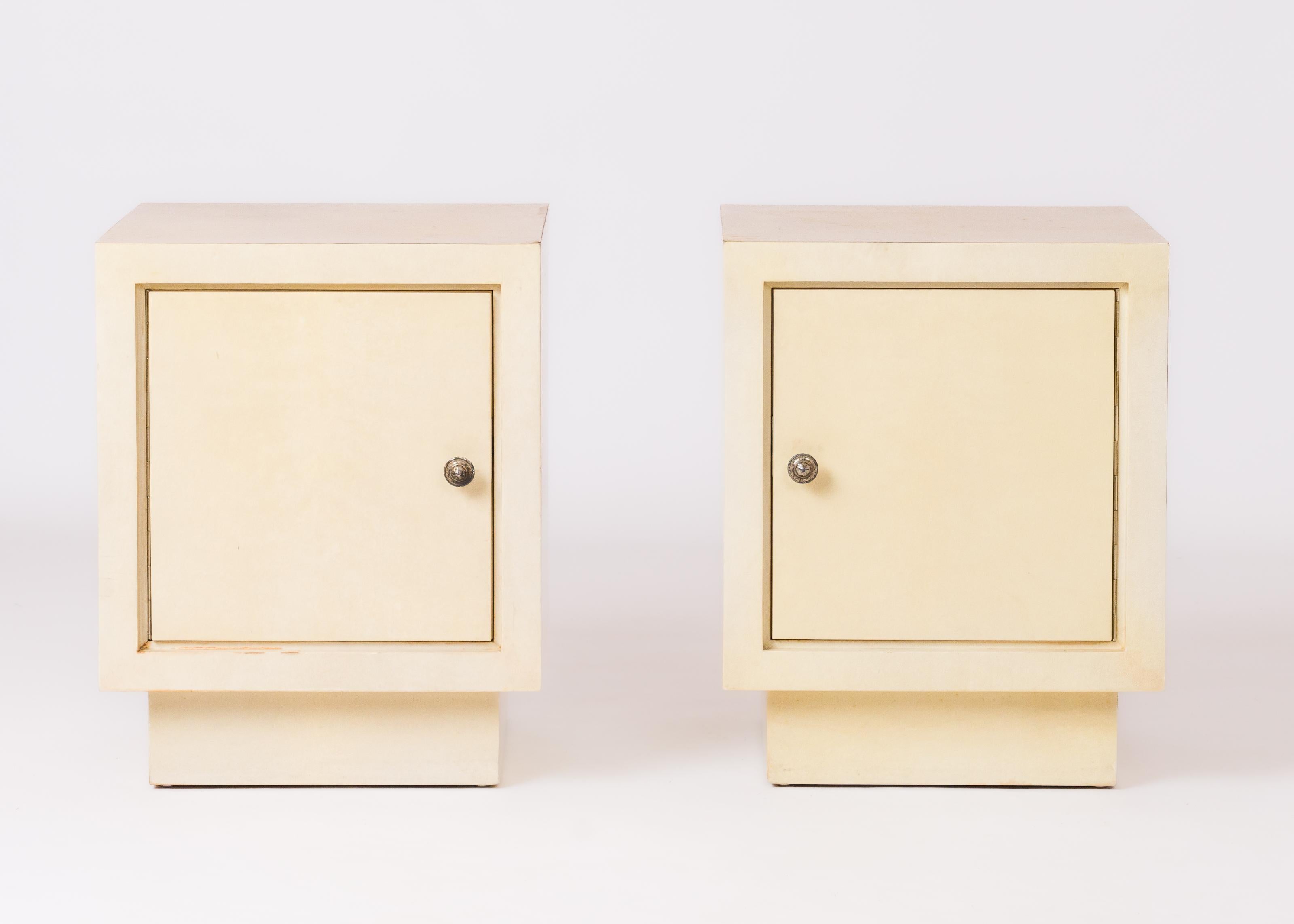 Parisian chic 1950's creme velum square night stands with inner lemon tree shelving. Silver plated bronze knobs. In good vintage condition with minor markings, stains and scruffs as exhibited in the pictures.
In the style of JM Frank.
These night