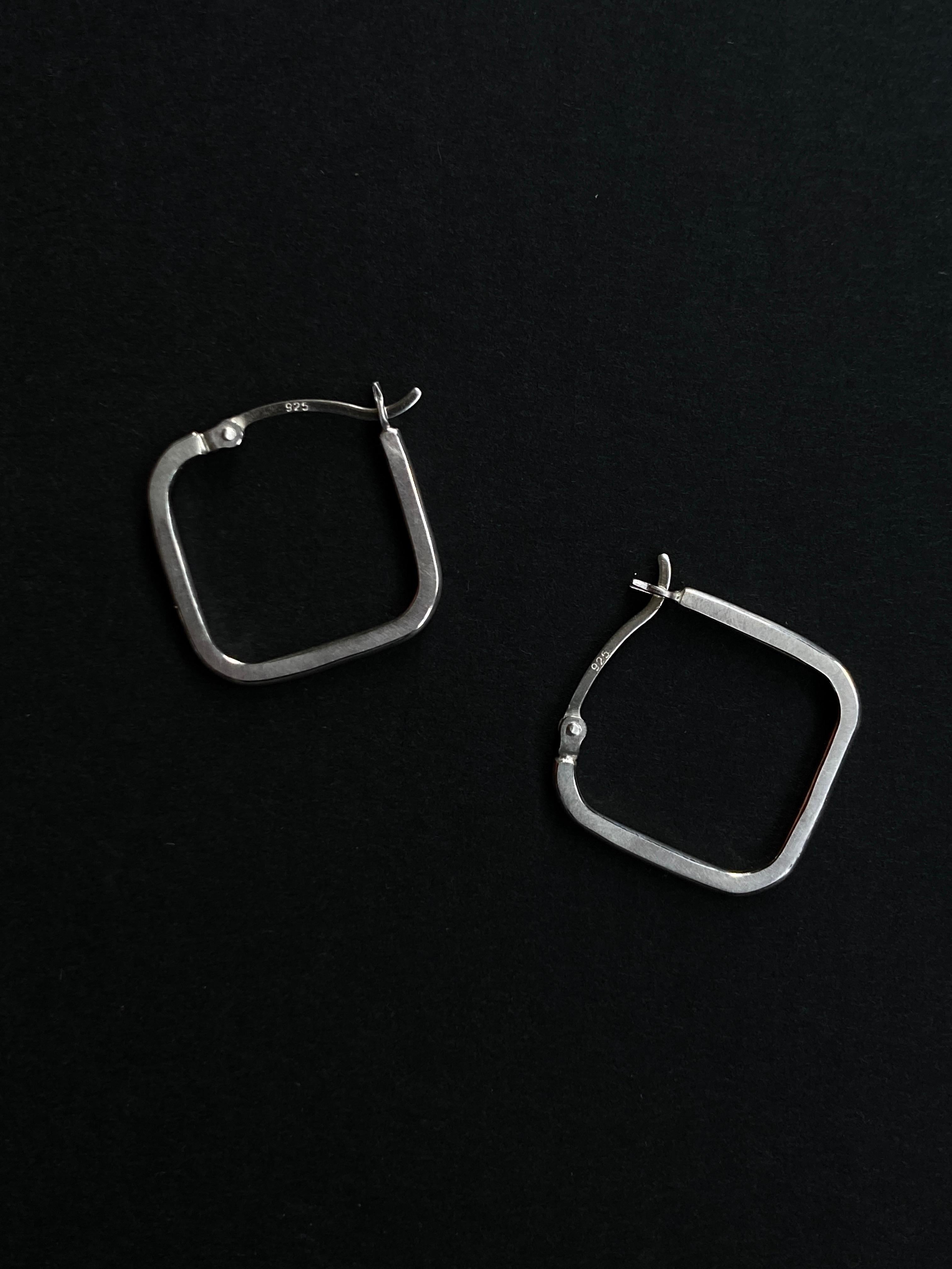These lightweight earrings are a perfect alternative to standard pair of everyday hoops.
They are made in silver wire and are finished with a matte sheen with burnished edges to catch the light when worn.

They come with a creole fitting, fastening