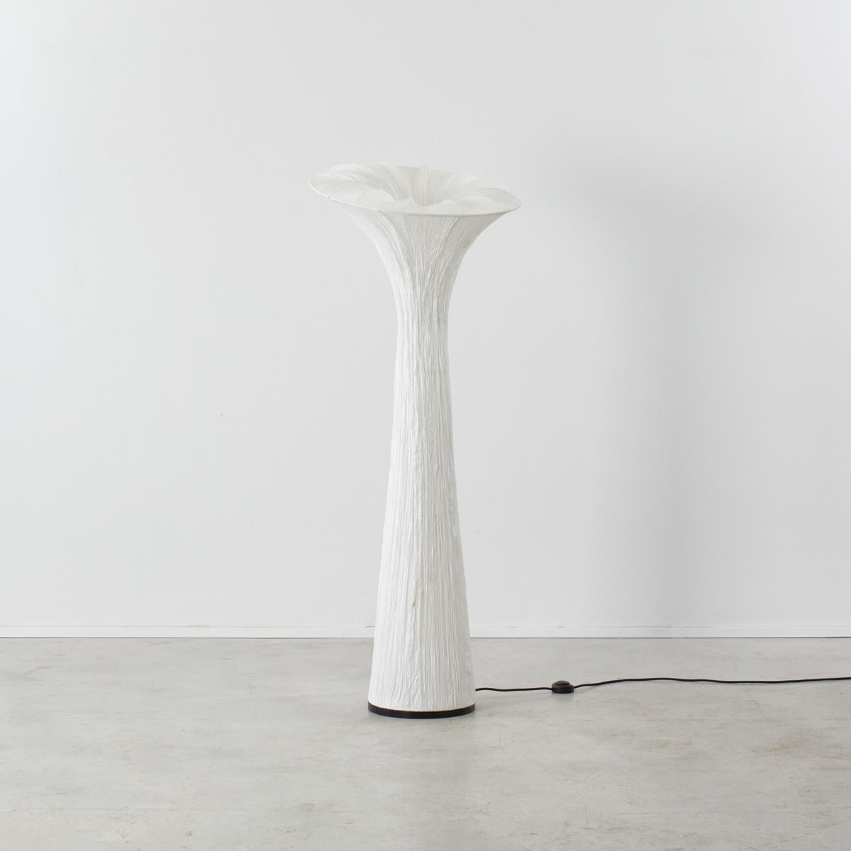 A distinctive lamp in an elegant, organic shape. The crinkly texture of the paper-fabric shade, which emulates the membrane of a petal, casts a lovely warm light. We see reminders of Issey Miyake’s Pleats clothing and Ingo Maurer’s crepe paper