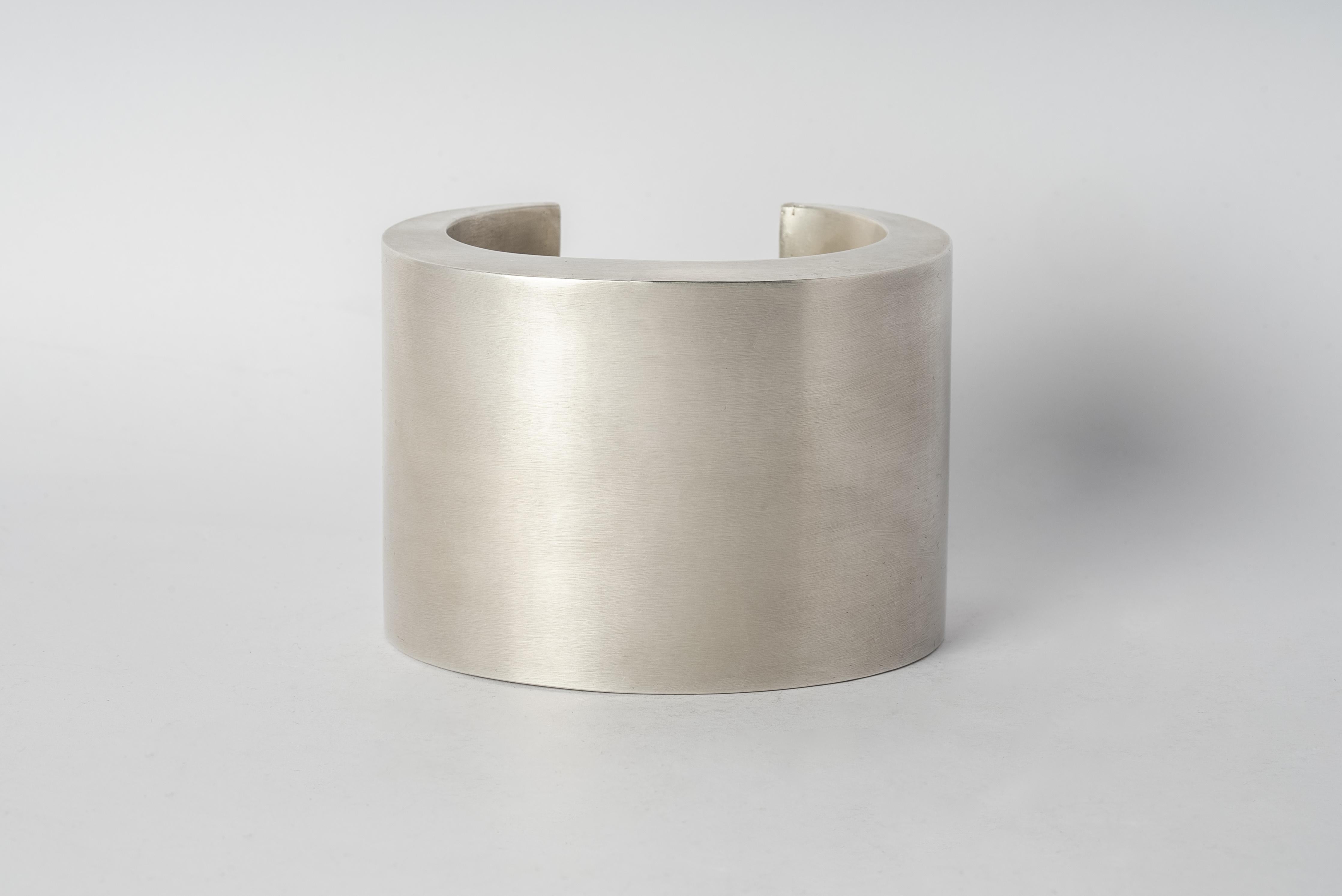 Bracelet in brass. Brass substrate is electroplated with silver and then dipped into acid to create the subtly destroyed surface. This piece is 100% hand fabricated from metal plate; cut into sections and soldered together to make the hollow three