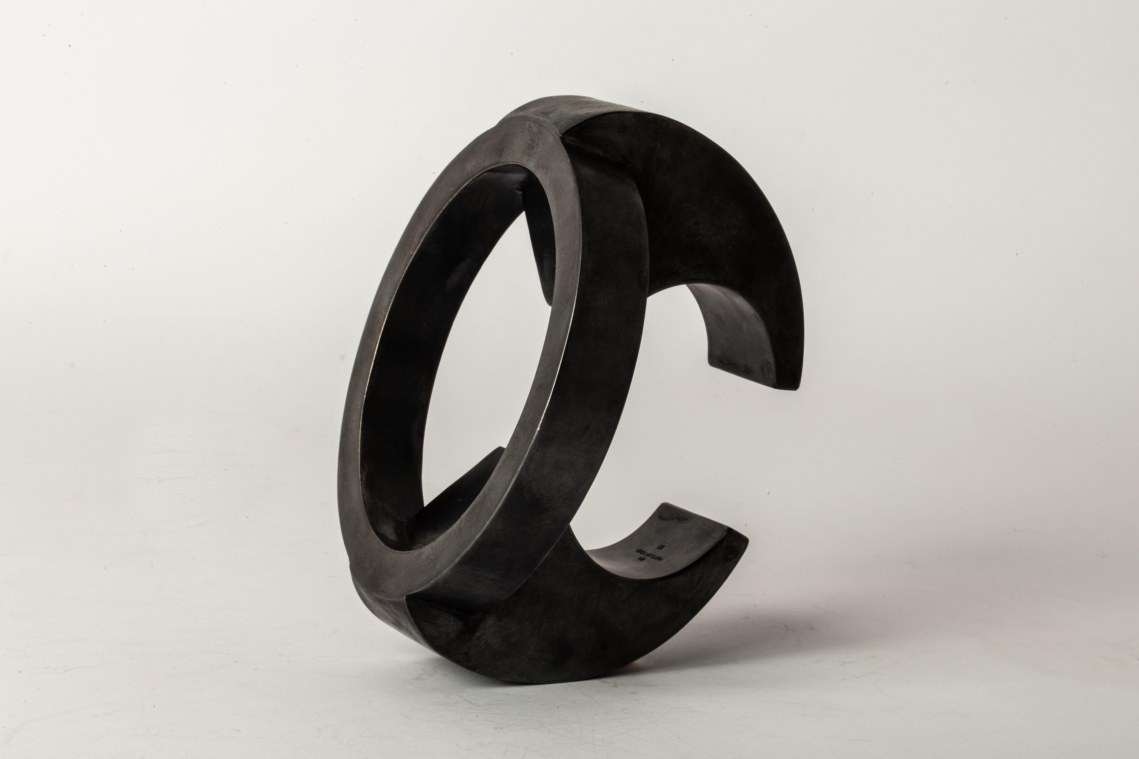 Bracelet in black sterling. Black Sterling is a surface oxidation of sterling silver. This piece is 100% hand fabricated from metal plate; cut into sections and soldered together to make the hollow three dimensional form.
Diameter of Bracelet Top :