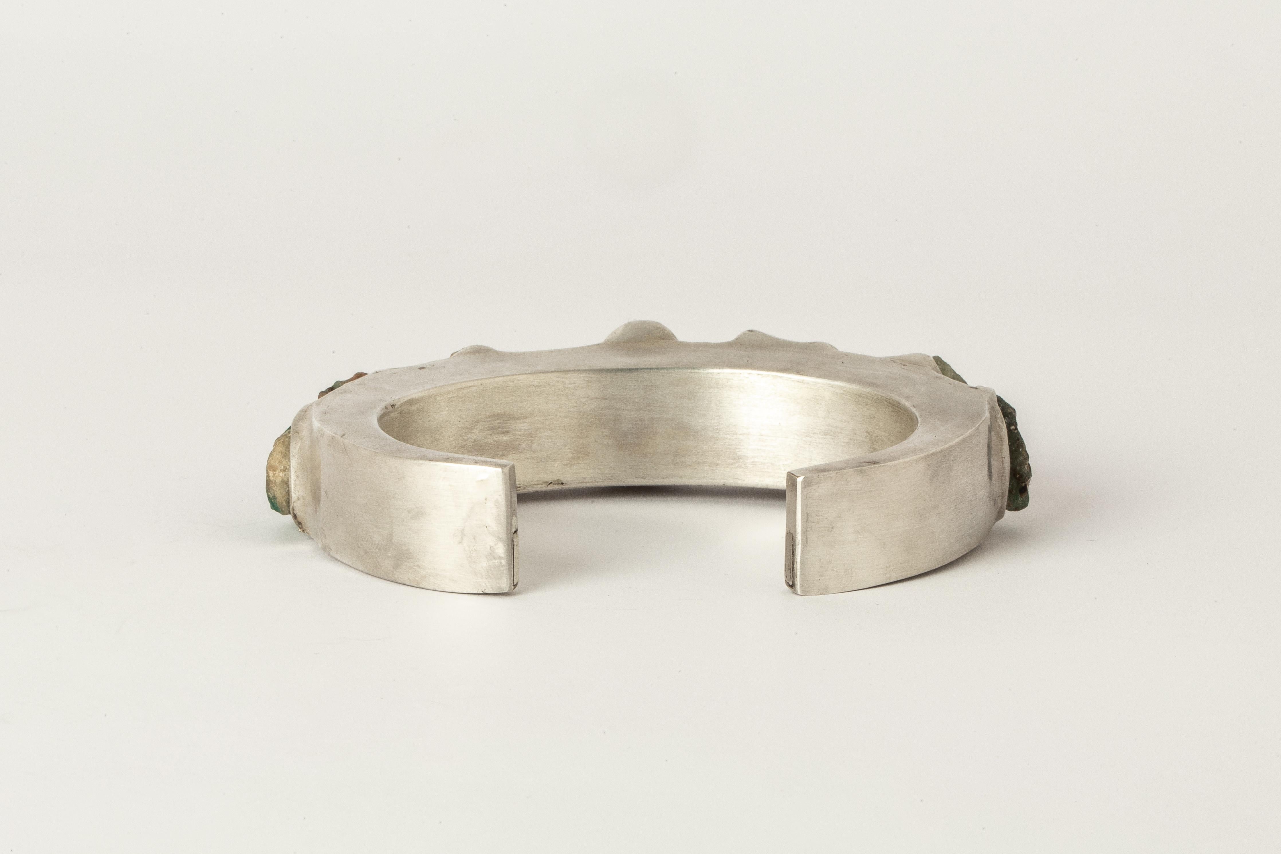 Bracelet in acid treated silver plated brass, matte sterling silver, and rough grandidierite. We use facet-grade rough gemstones which means that the traditional intention of this rough material is cut faceted stones. This assures the highest
