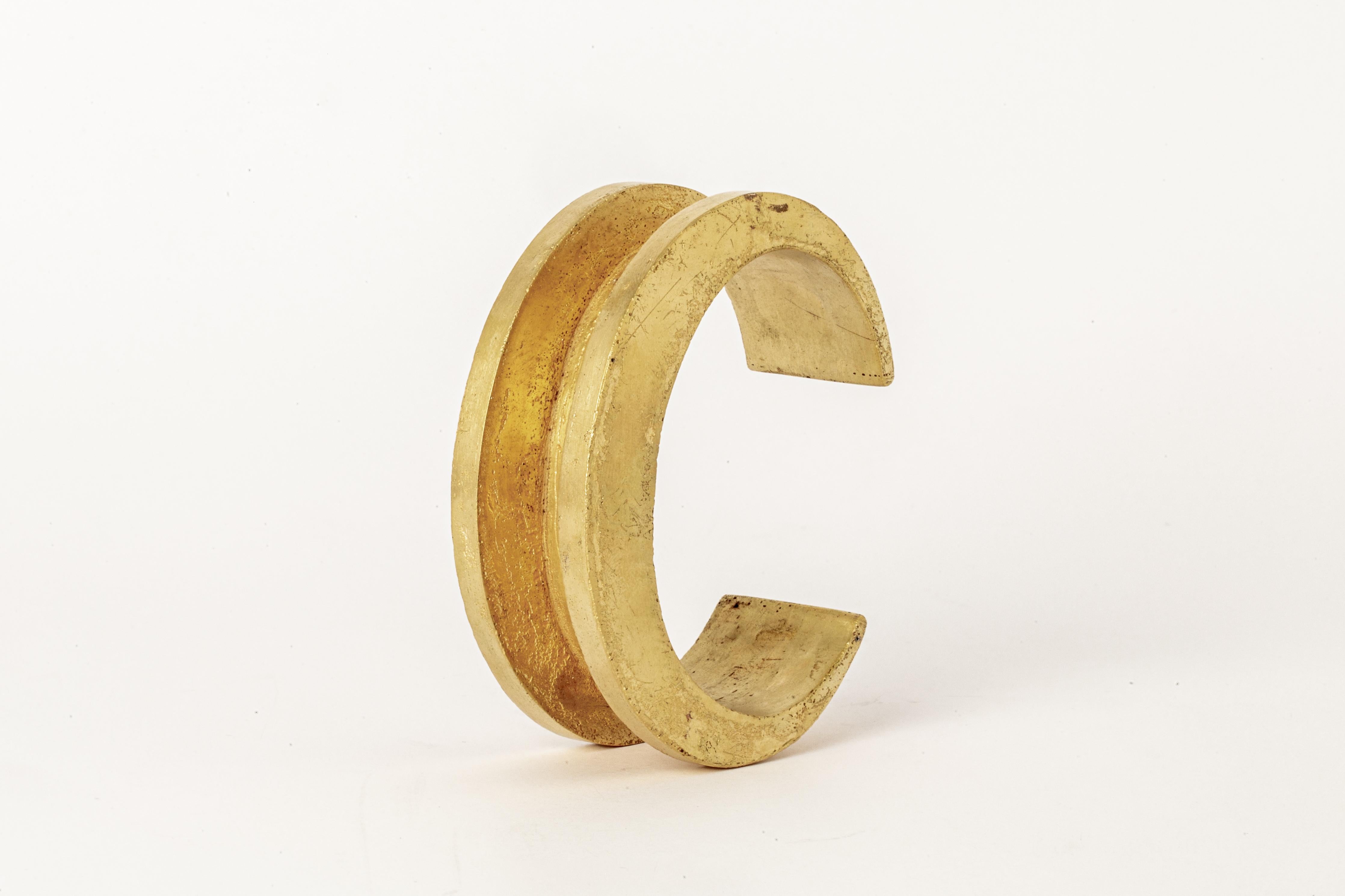 Bracelet in brass. Brass substrate is electroplated with 18k gold and then dipped into acid to create the subtly destroyed surface. This piece is 100% hand fabricated from metal plate; cut into sections and soldered together to make the hollow three