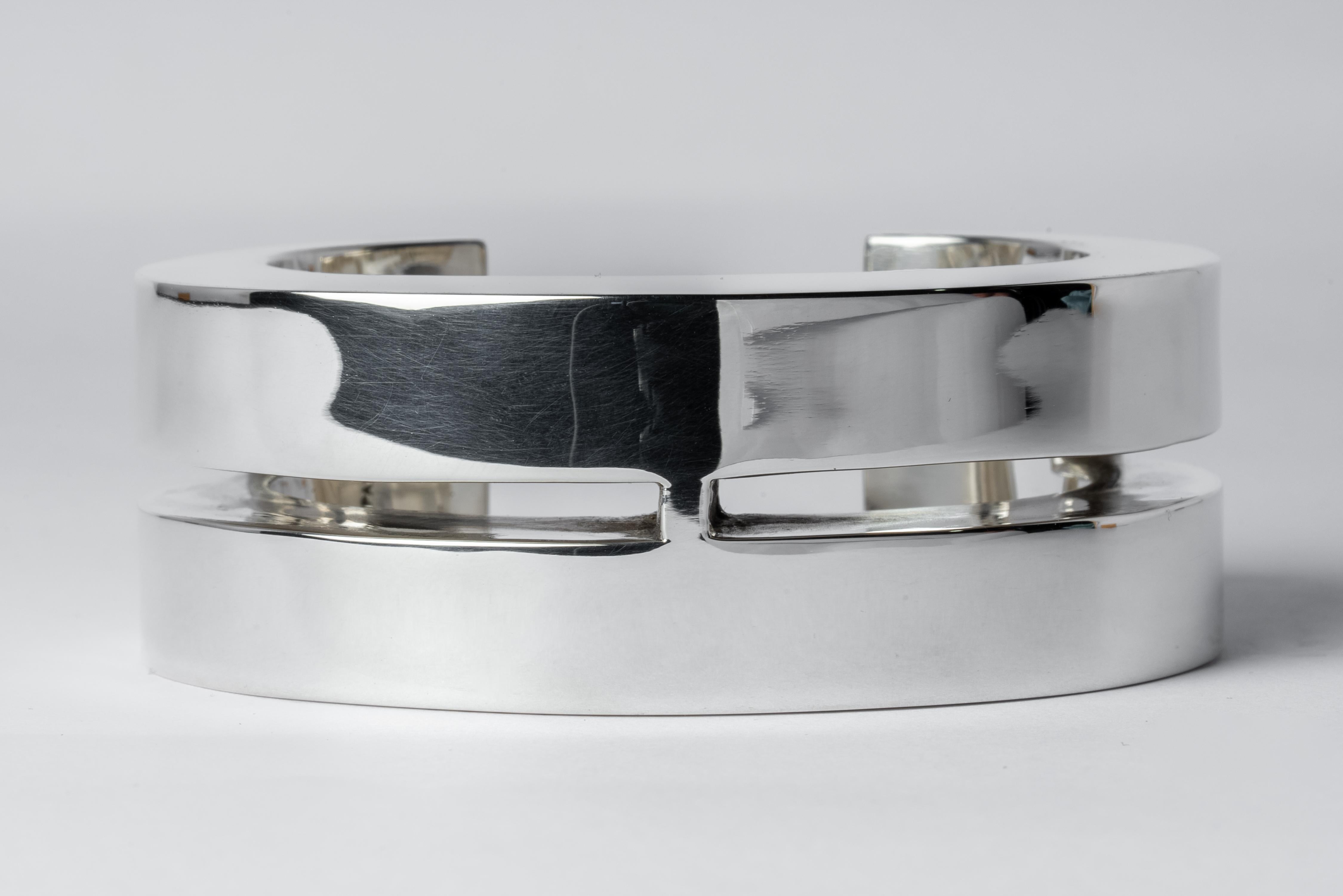 Bracelet in polished sterling silver. This piece is 100% hand fabricated from metal plate; cut into sections and soldered together to make the hollow three dimensional form. If sterling silver, the sheet metal is made by hand. The silver is melted