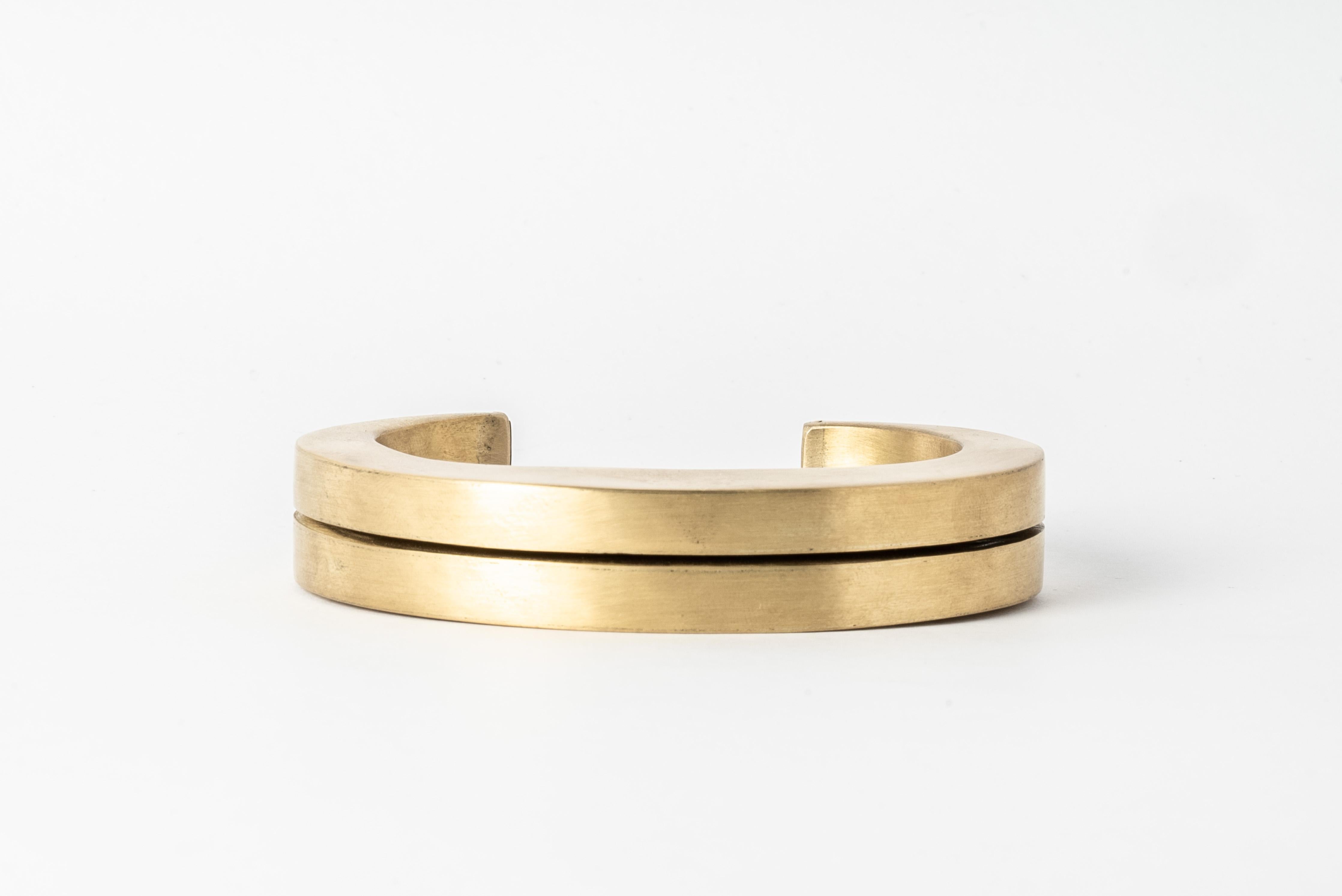 Bracelet in matte brass. This piece is 100% hand fabricated from metal plate; cut into sections and soldered together to make the hollow three dimensional form.