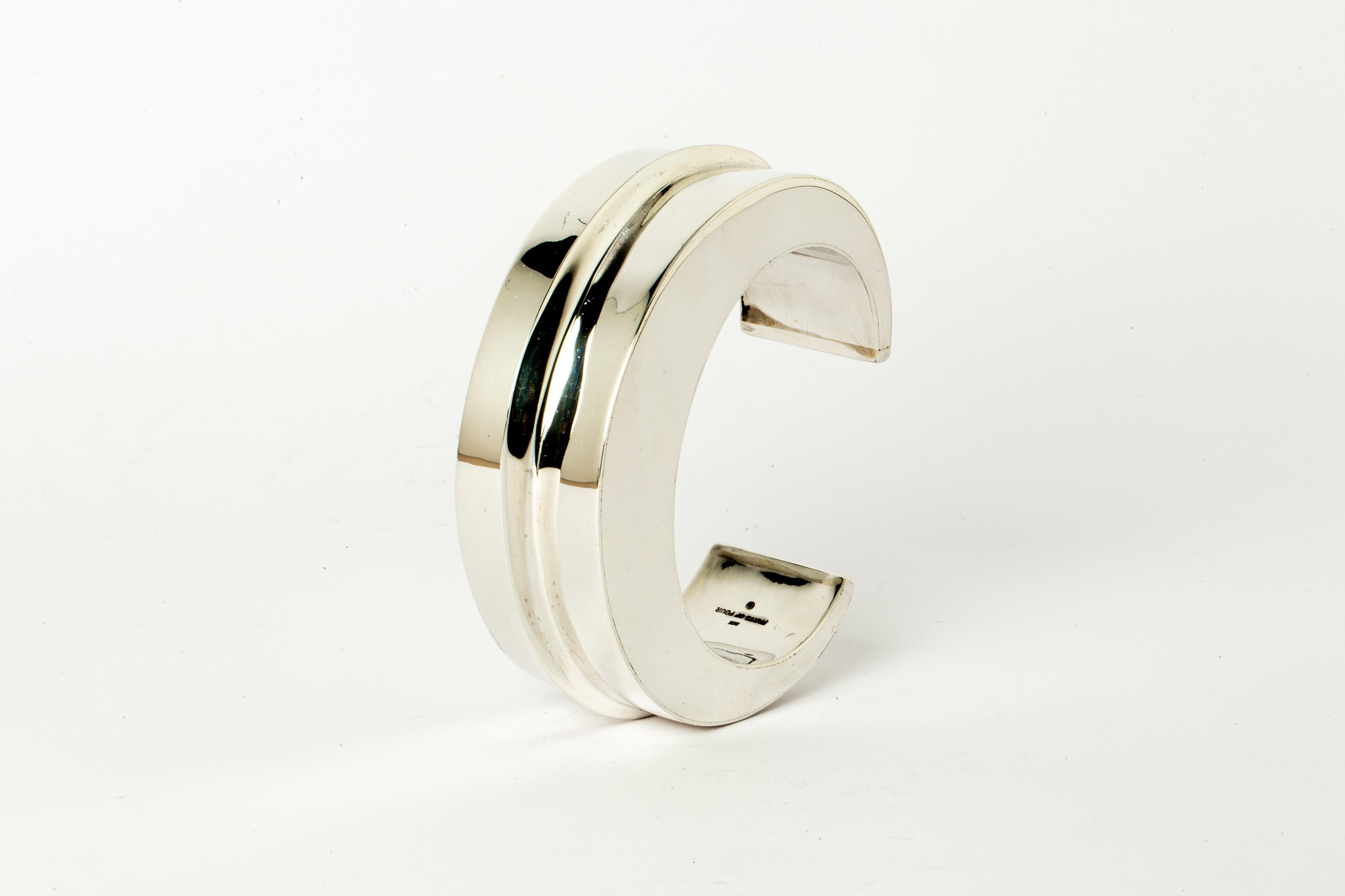 Bracelet in polished sterling silver. This piece is 100% hand fabricated from metal plate; cut into sections and soldered together to make the hollow three dimensional form. Foldforming is the process of folding metal. The process of folding and