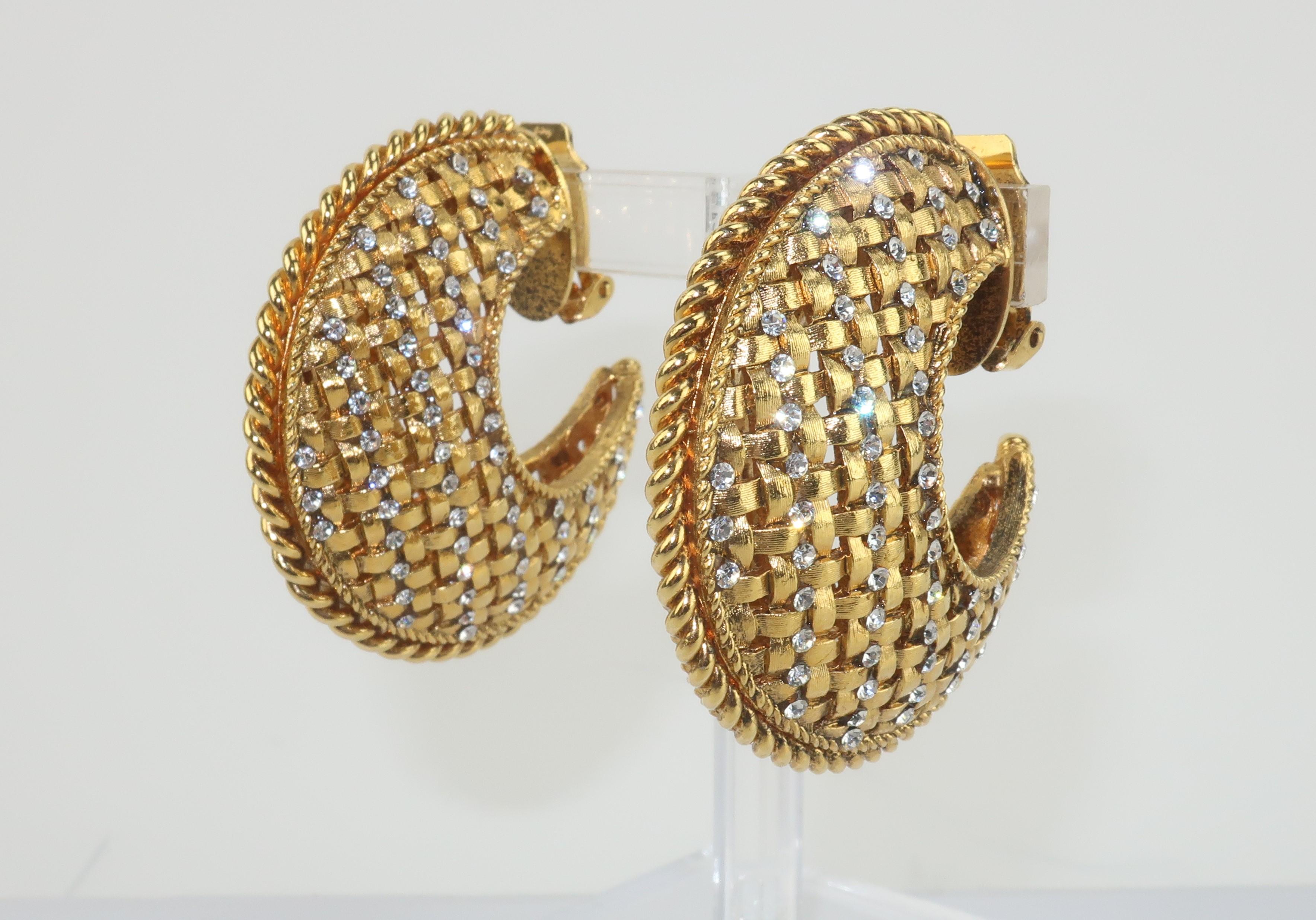 Large 1980's crescent shaped hoop earrings with a beautifully detailed gold tone lattice pattern accented by crystal rhinestones.  Outfitted with clip on hardware.  Unsigned though made with quality details and a statement making style.  From the