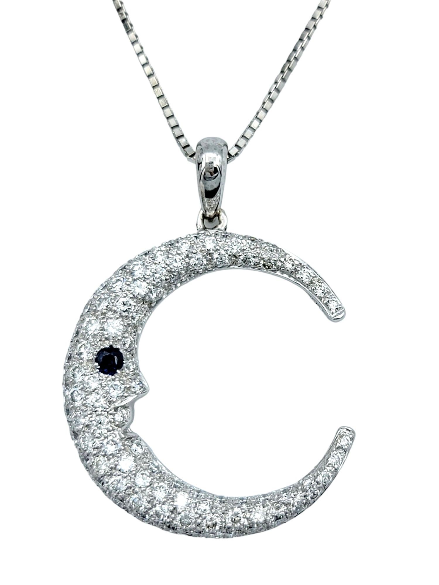 This crescent moon pendant necklace exudes celestial charm with its shimmering diamond pave design set in 14 karat white gold. The delicate curves of the moon are adorned with sparkling diamonds, creating a captivating celestial silhouette.

Adding