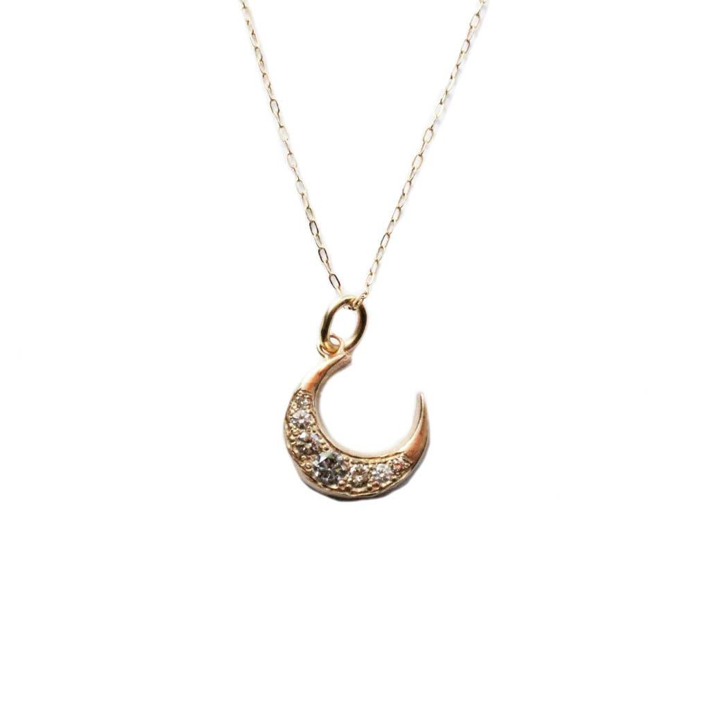 This elegant petite crescent moon is cast in solid 14k gold and set with pave diamonds in salt and pepper and champagne hues. This is strung on a solid 18 inch gold chain .  