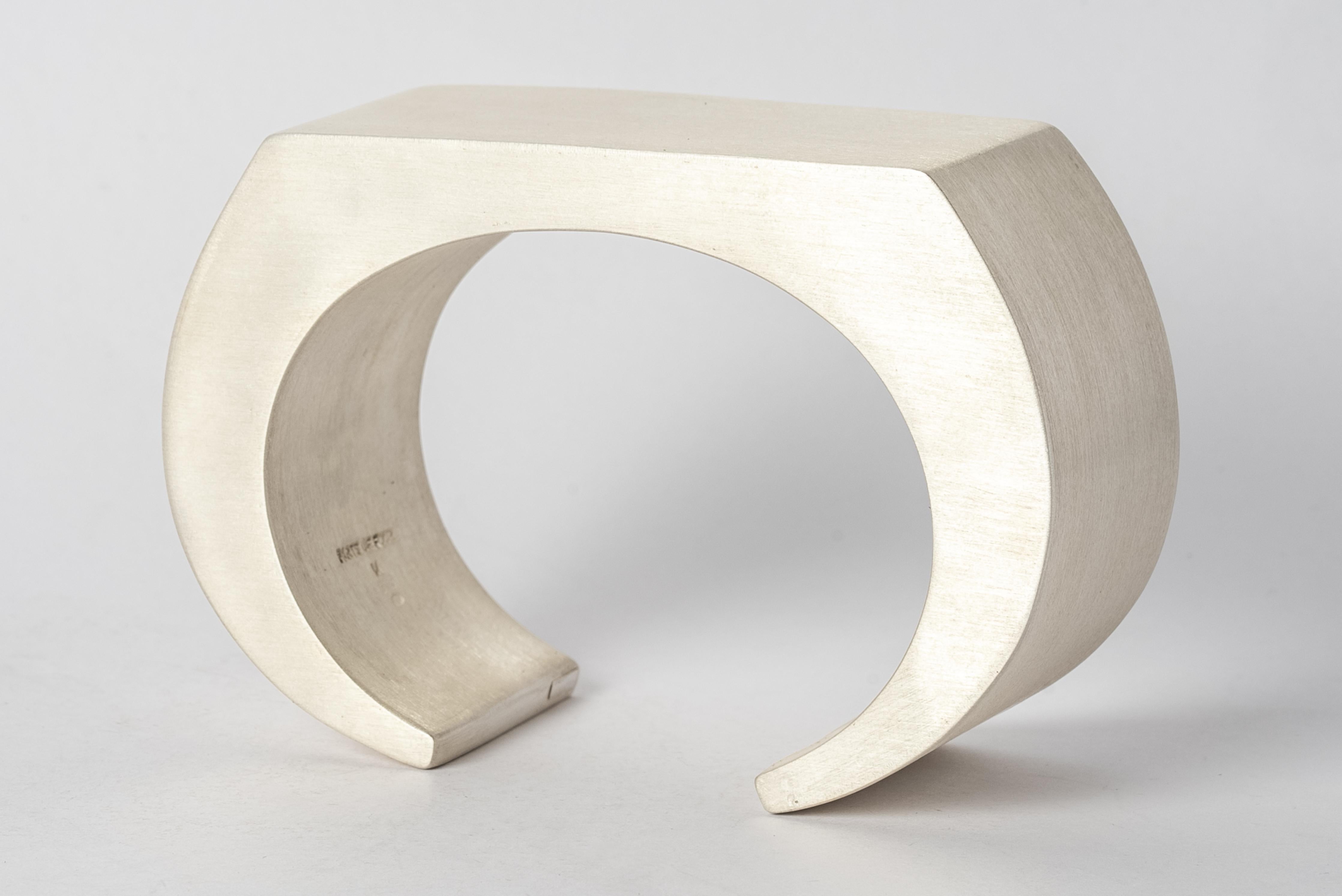 Bracelet in sterling silver. This piece is 100% hand fabricated from metal plate; cut into sections and soldered together to make the hollow three dimensional form.
Dimensions Bracelet Top (WxL): 30 mm × 55 mm.