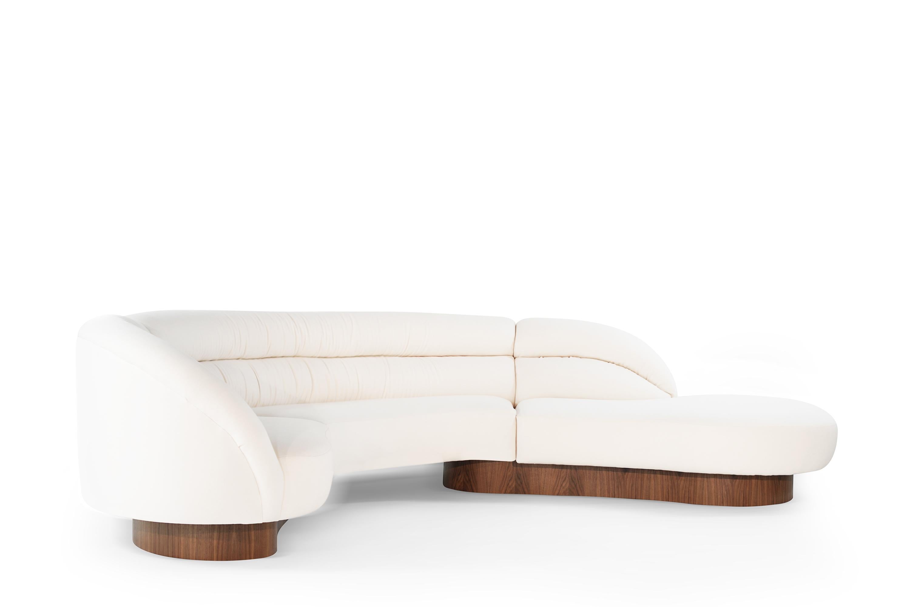 Extremely rare crescent sectional by Directional, circa 1970s. All insides including foam, straps, dacron, and spring system have been updated. Re-upholstered in off-white soft wool by Holly Hunt. Support bases have all been updated in natural