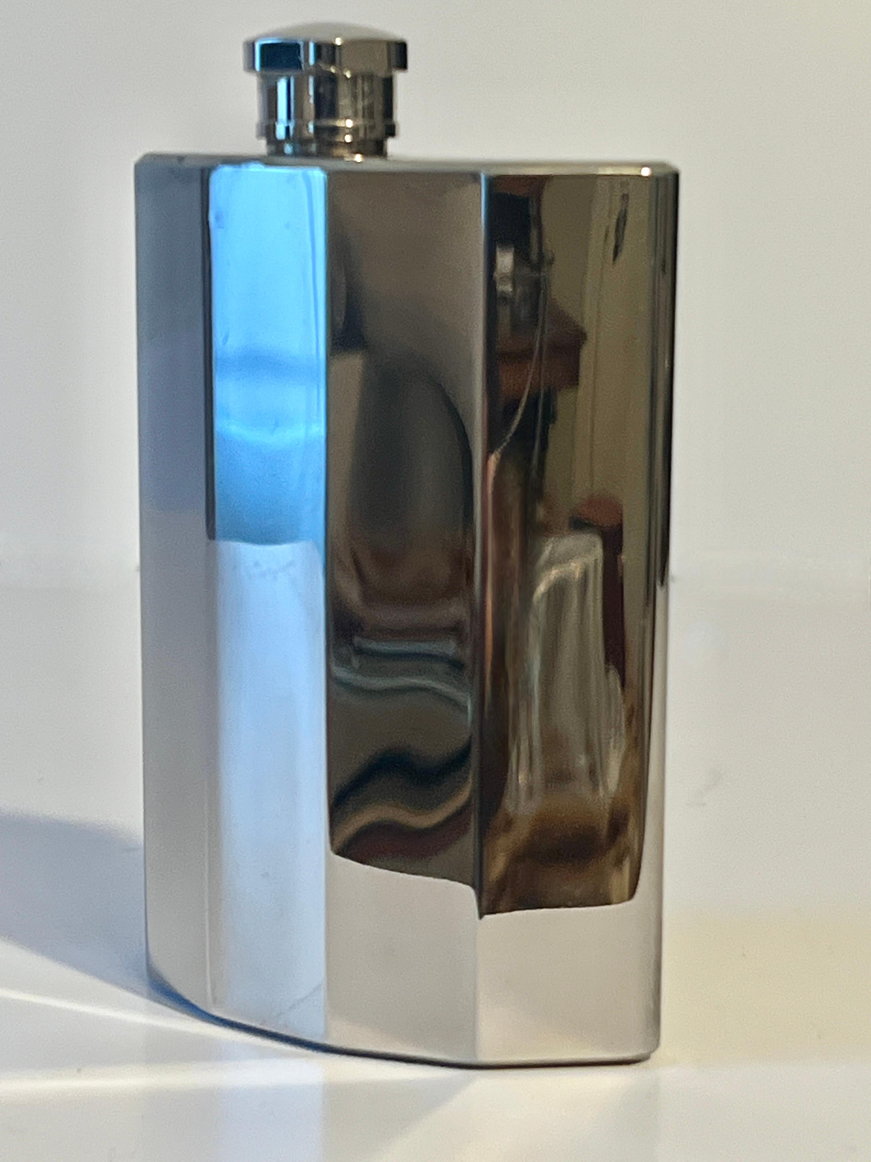 A stylish and sleek Stainless Steel polished flask.  A unique curvature to the shape with ribbed edges makes this piece, not only a practical way to store spirits on the go, but also in unique style.

A compliment to any breast coat pocket or